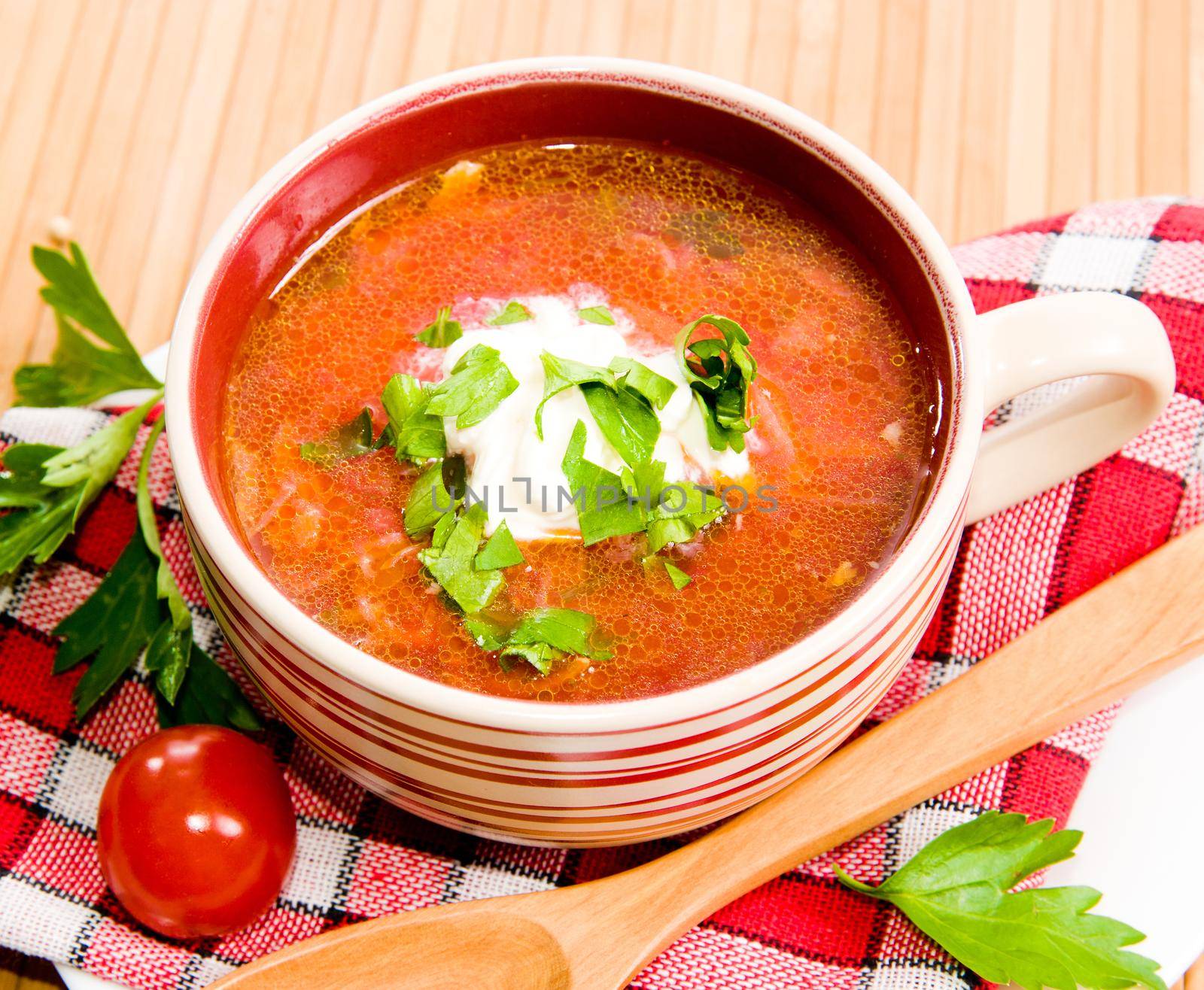 tomato soup with tomatoes in background ower white