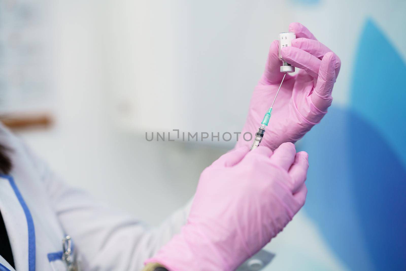 Aesthetic doctor preparing the syringe with the botulinum toxin to be injected in her patient.
