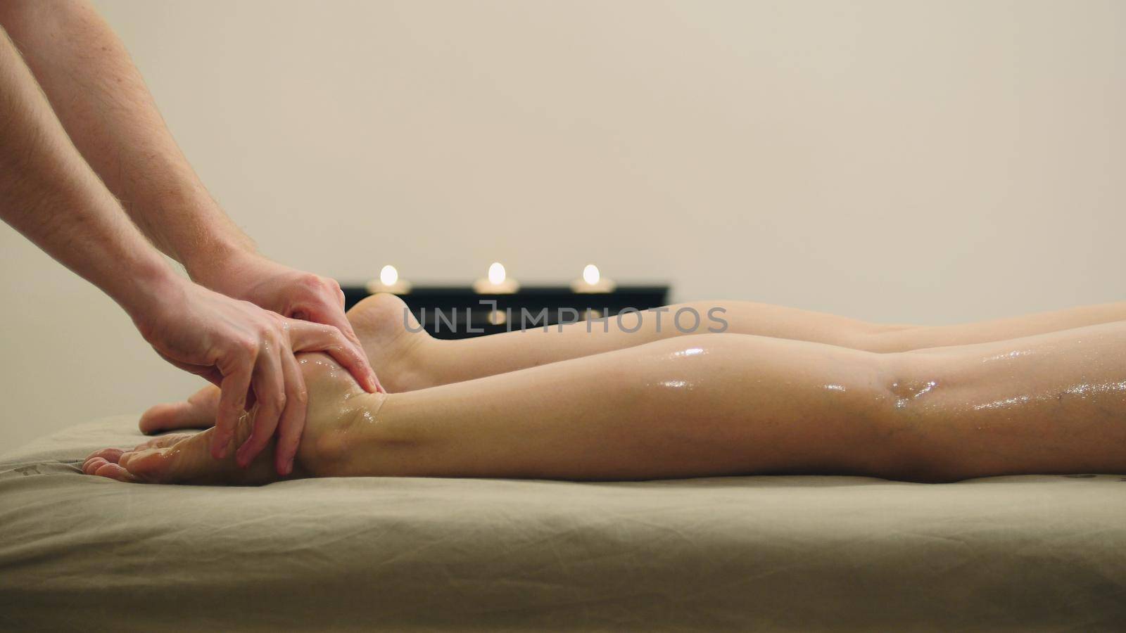 Oil massage for footsteps. Relaxation treatment for young woman, close up by Studia72