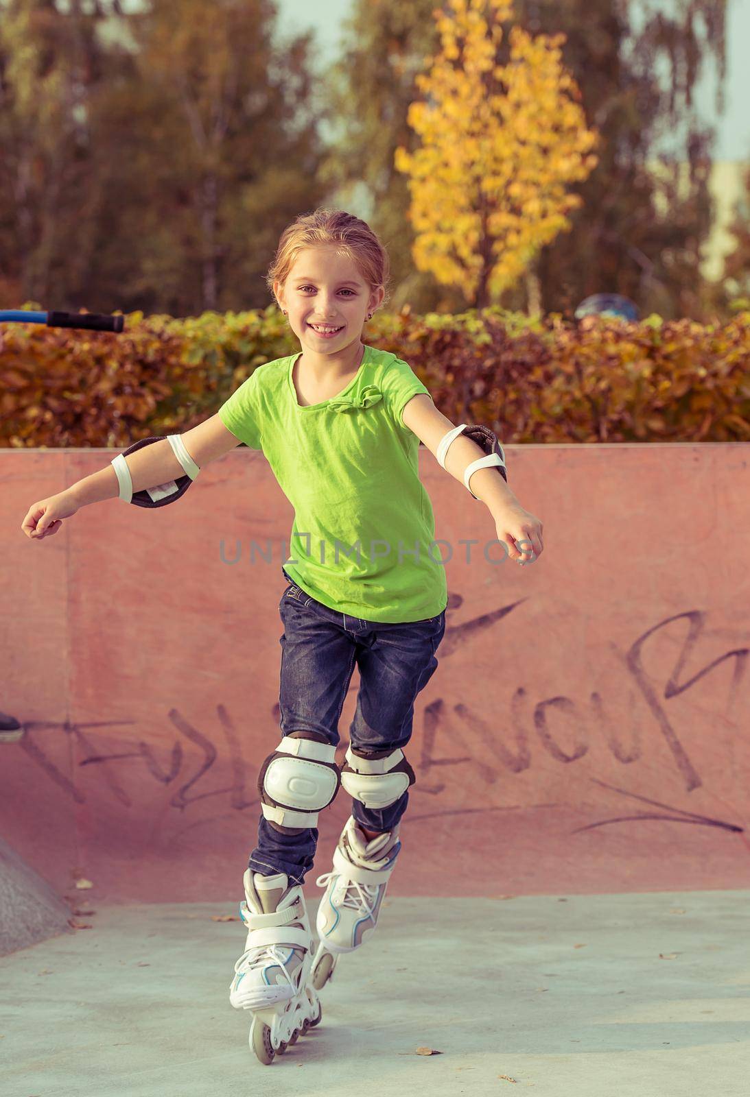 Little girl on roller skates at a park