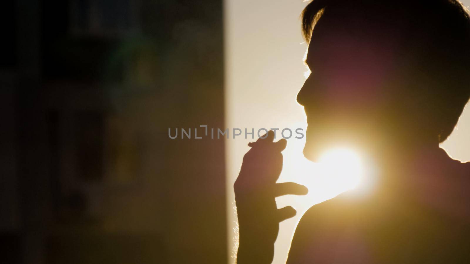 Portrait of a lonely man smoking a cigarette, silhouette