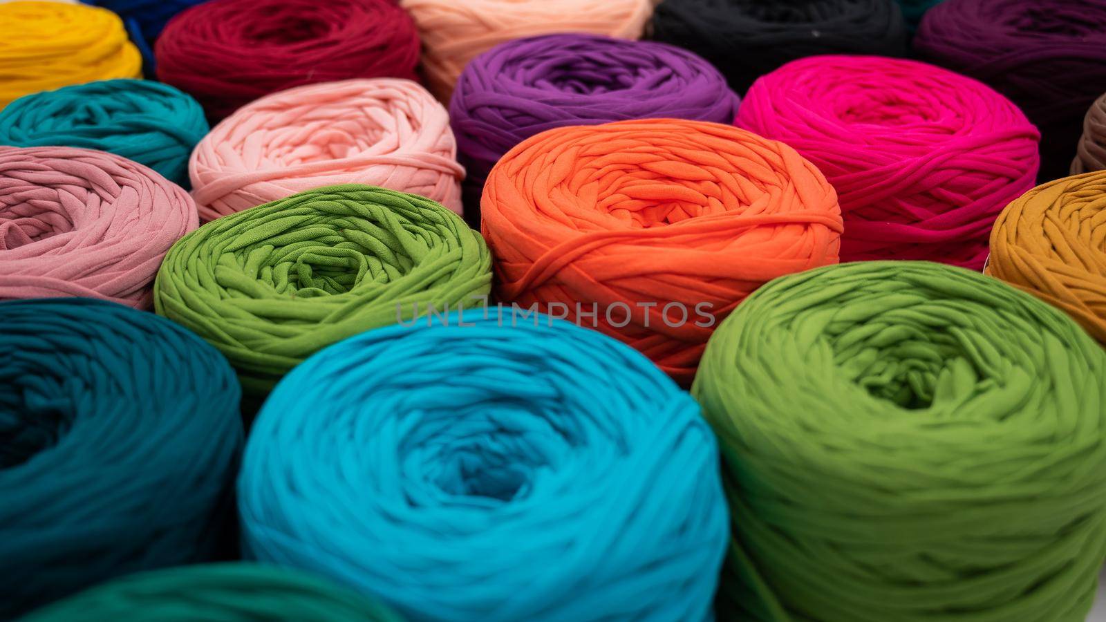 Close-up of multi-colored cotton skeins. Shop assortment for handmade.