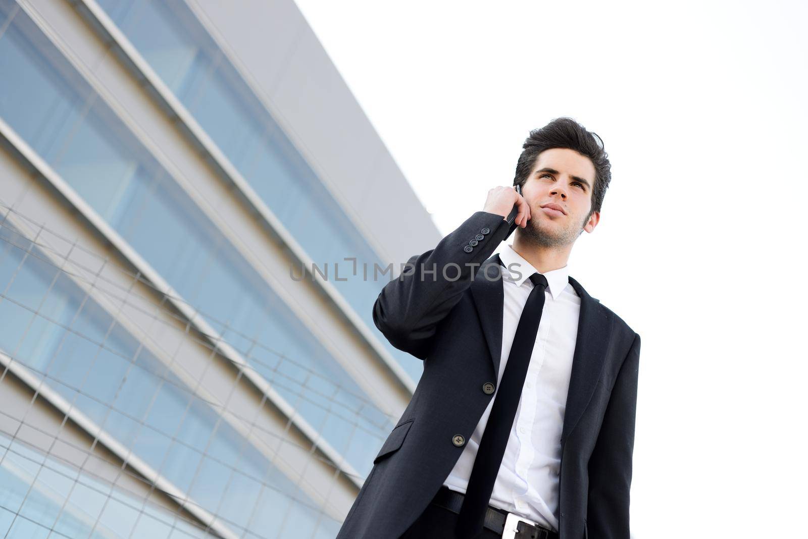Portrait of an attractive young businessman on the phone in an office building