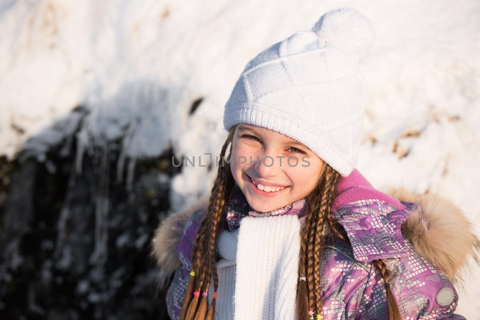 portrait of a little girl in white winter hat