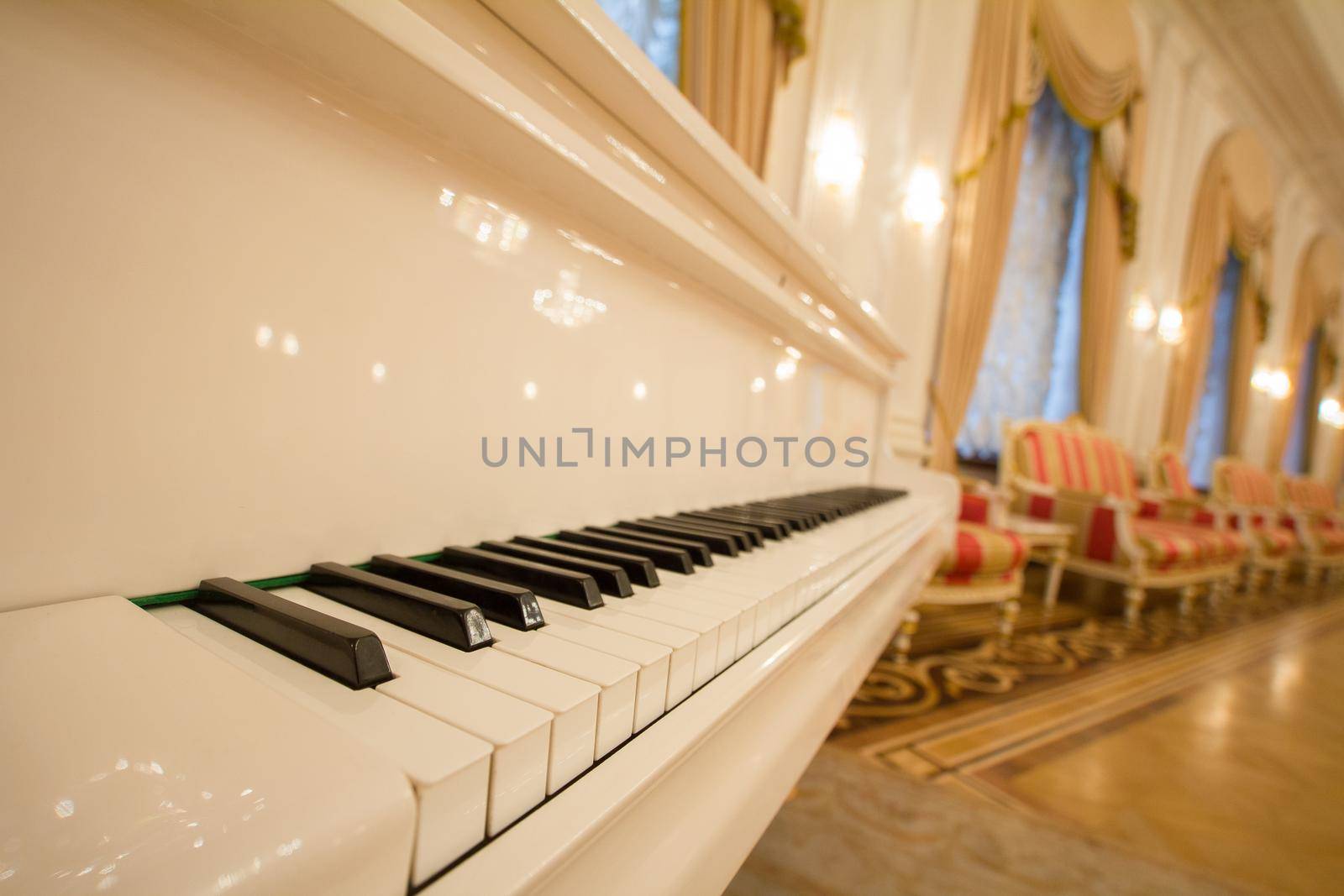 Classical Piano - white and black keys. Golden luxury ballroom, close up