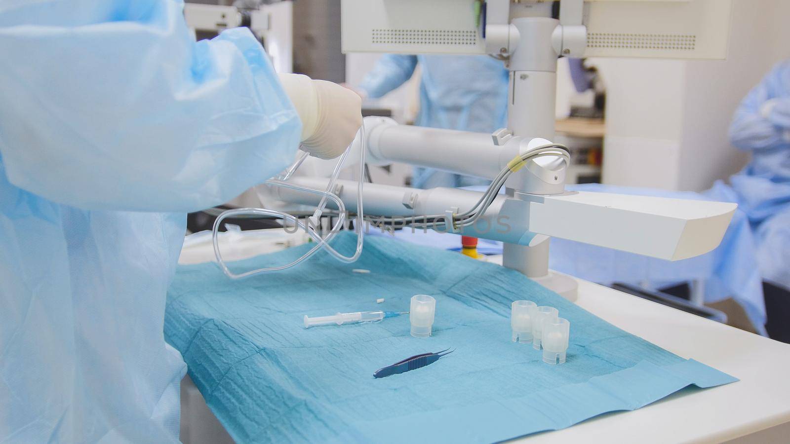 Surgeons and assistants prepare for surgery in an operating room - ophthalmology, close up