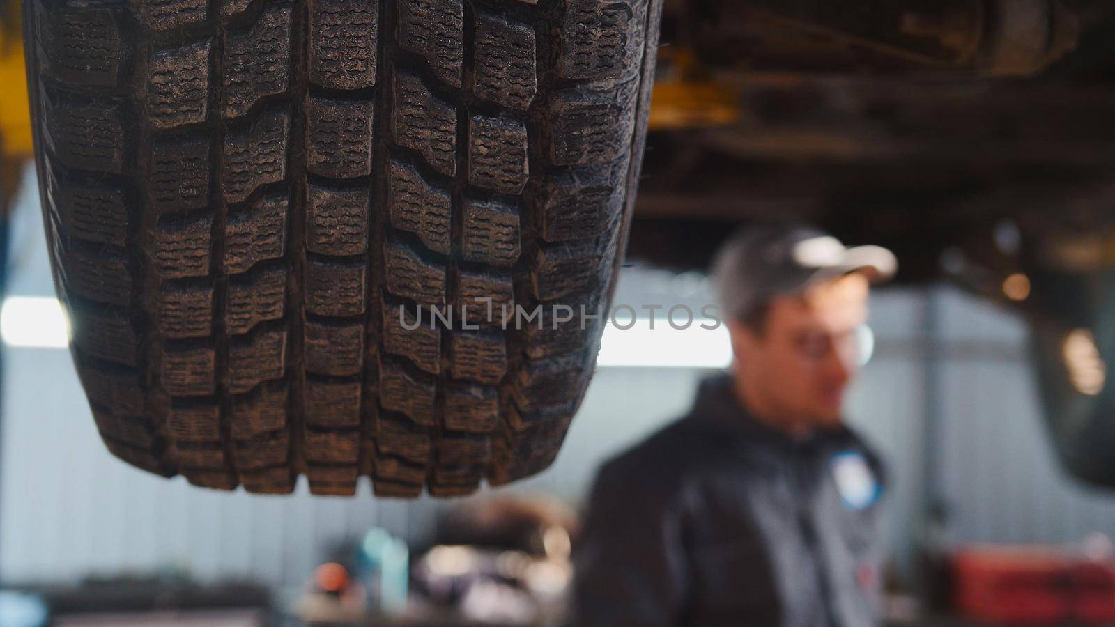 Garage automobile service - wheel, car checking, close up