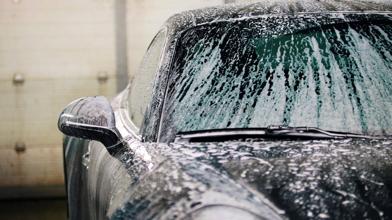 Washing a luxury car in the suds, close up