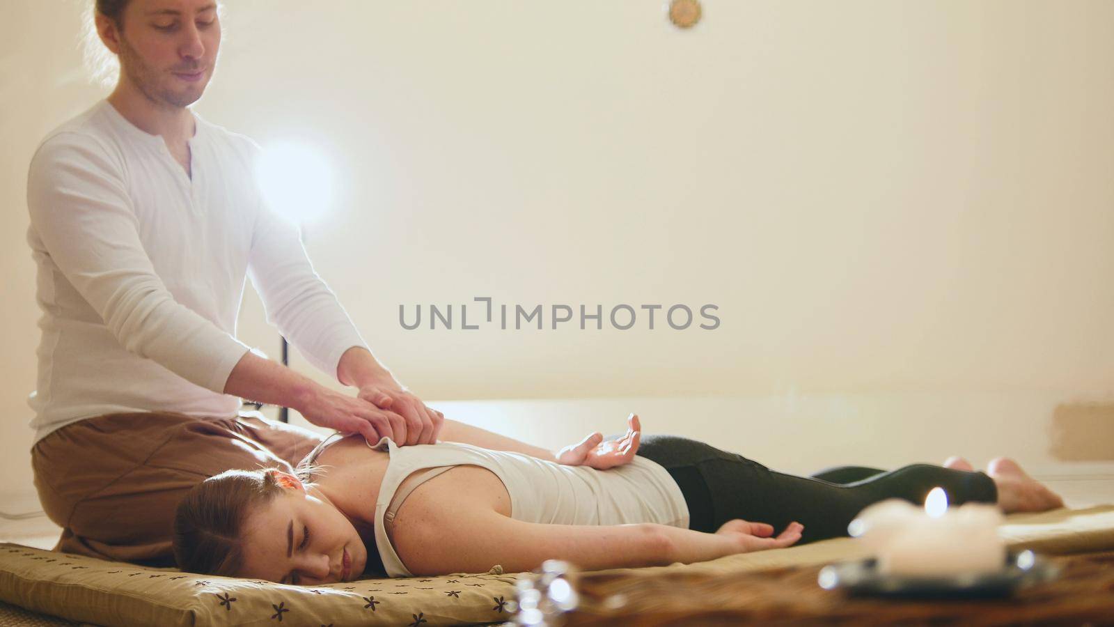 Thai massage - woman gets Thai traditional therapy for shoulders, slider