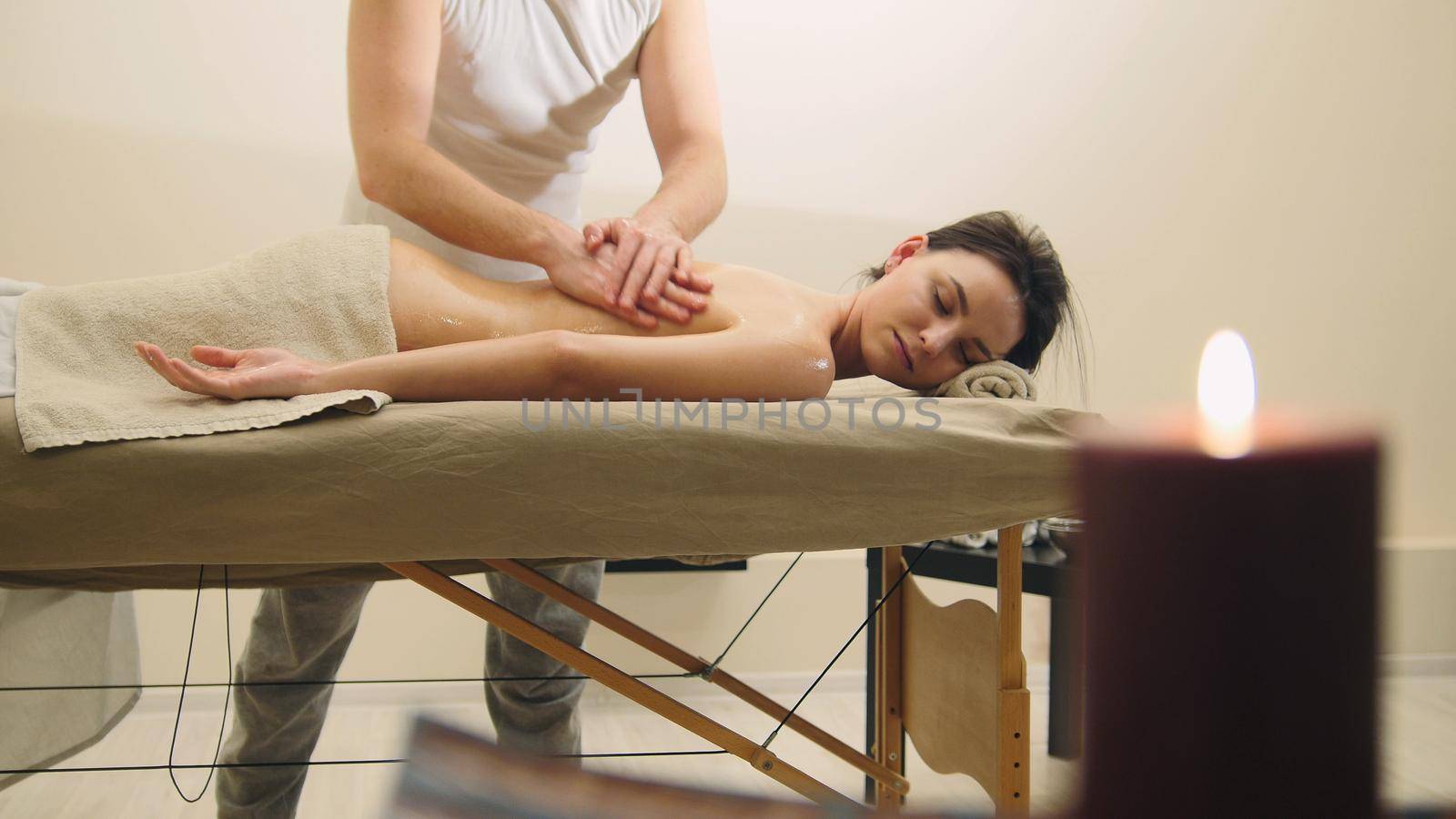 Attractive young woman receiving massage at spa. Relaxation treatment for caucasian model, close up view
