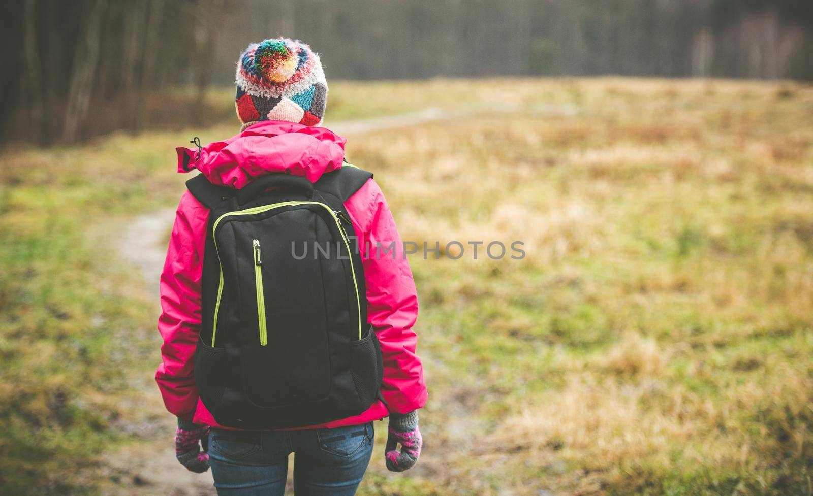 girl with a backpack going up the path