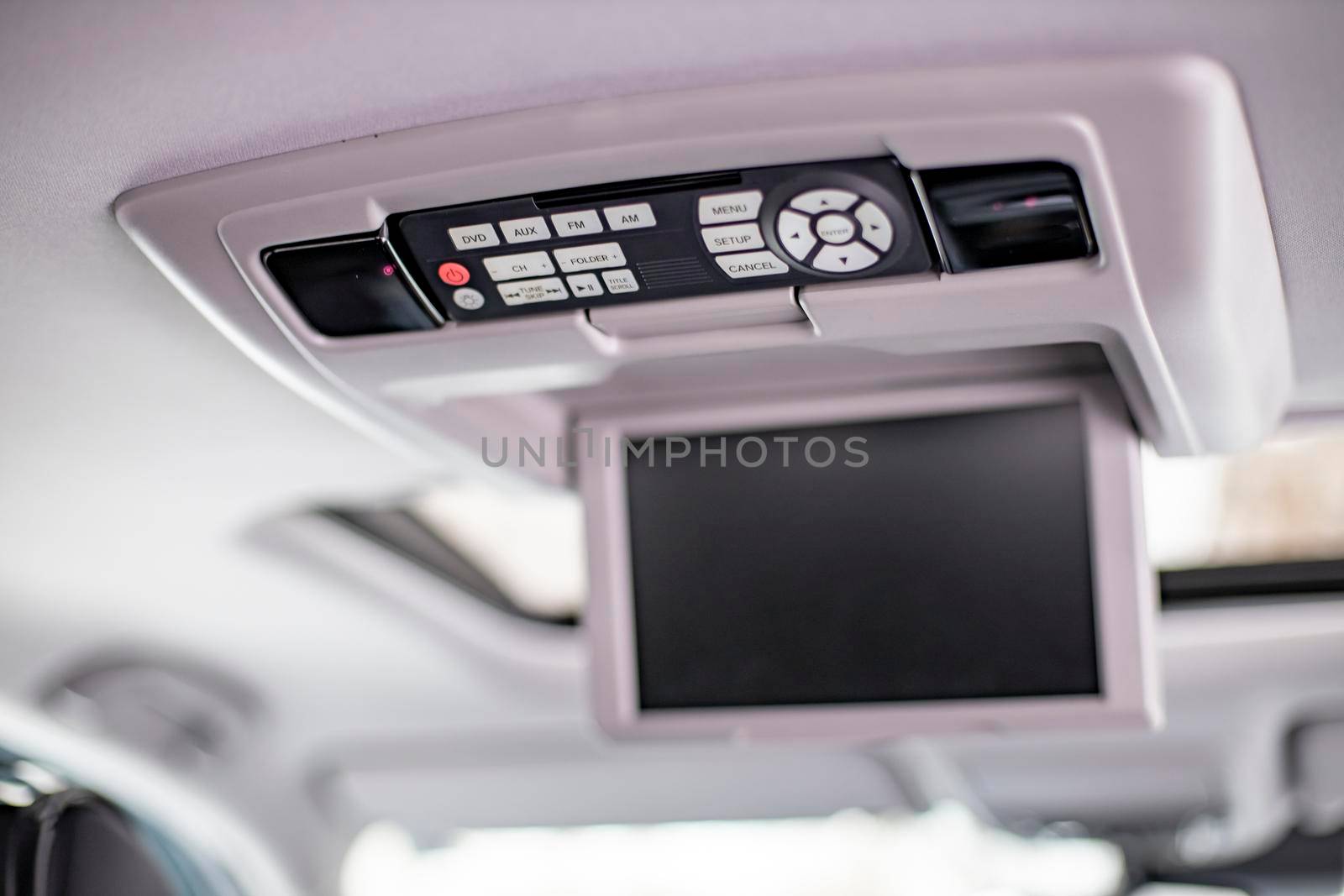 screen m multimedia system control panel on white ceiling of a modern car. close-up
