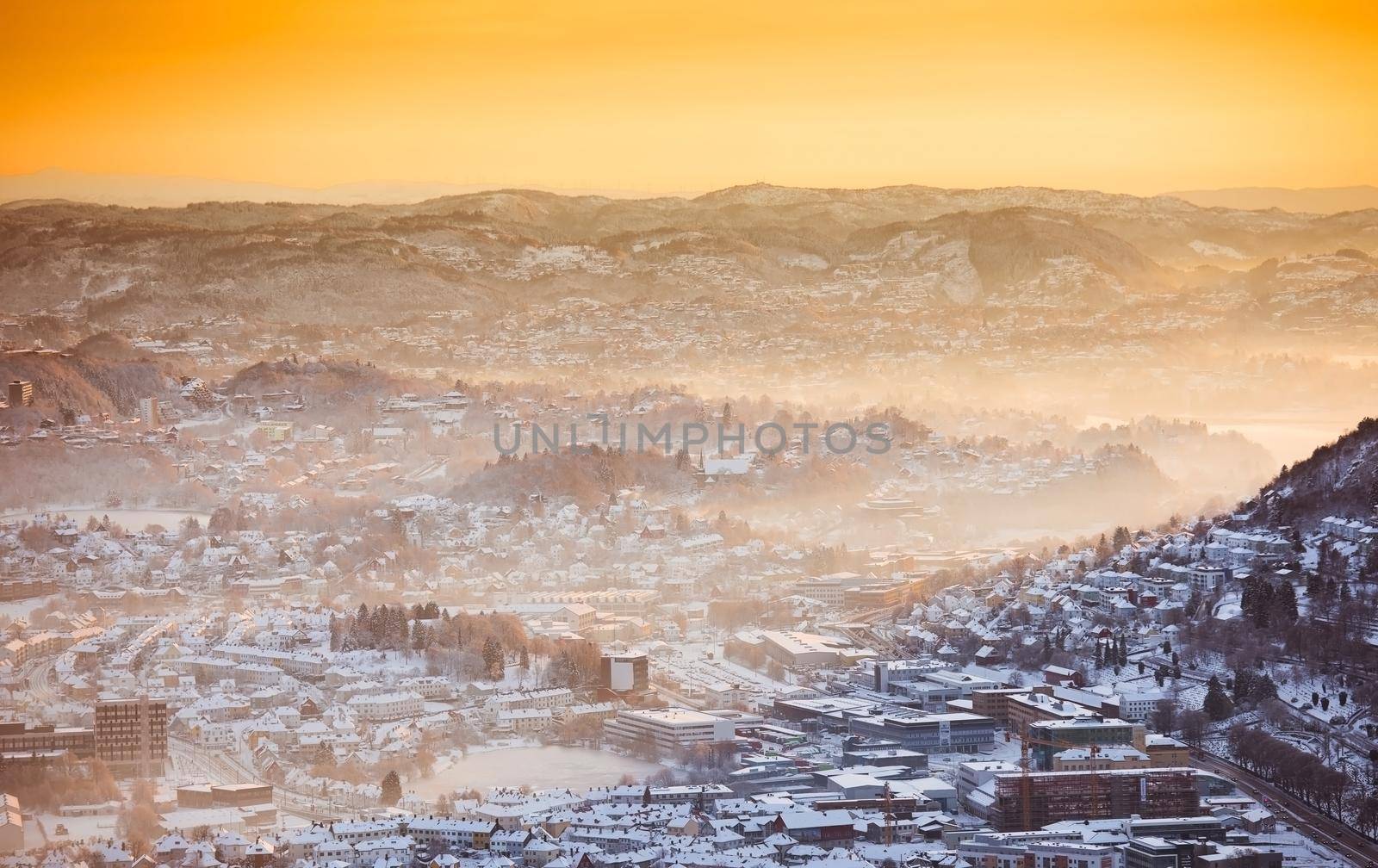 view of winter city with fog from the mountain top