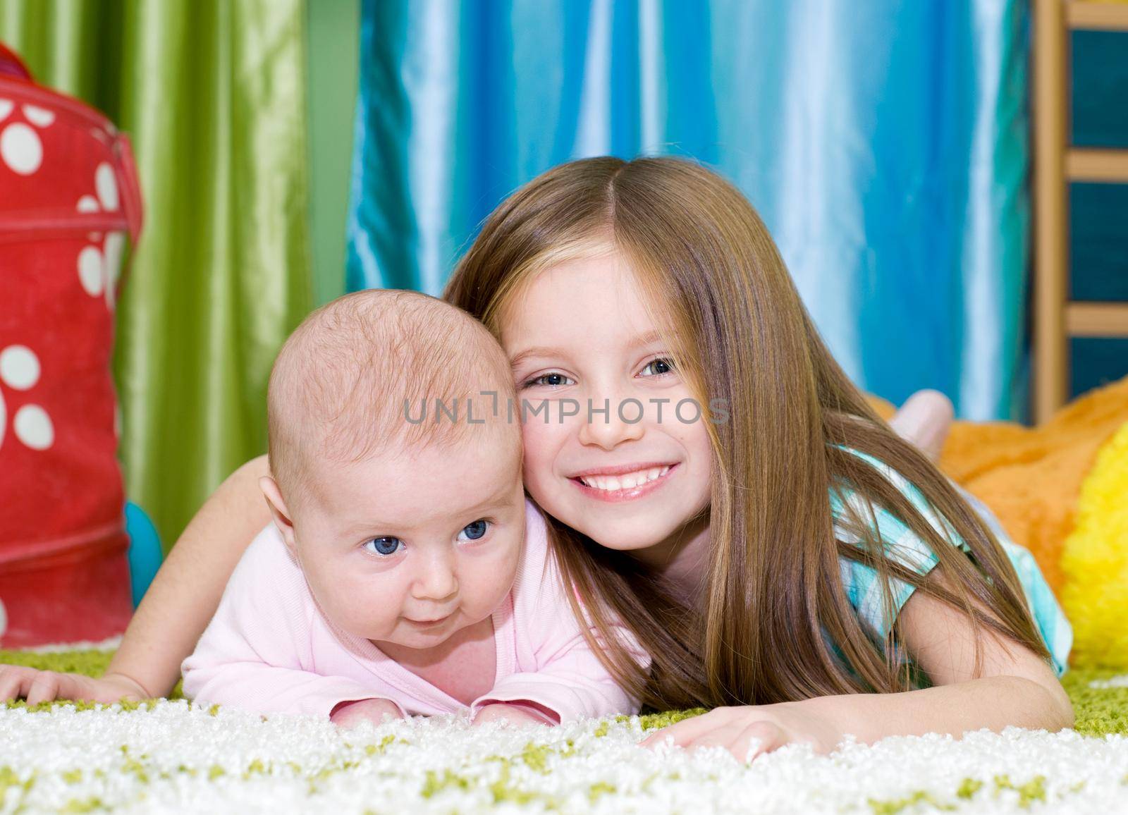 two smiling little sisters at home