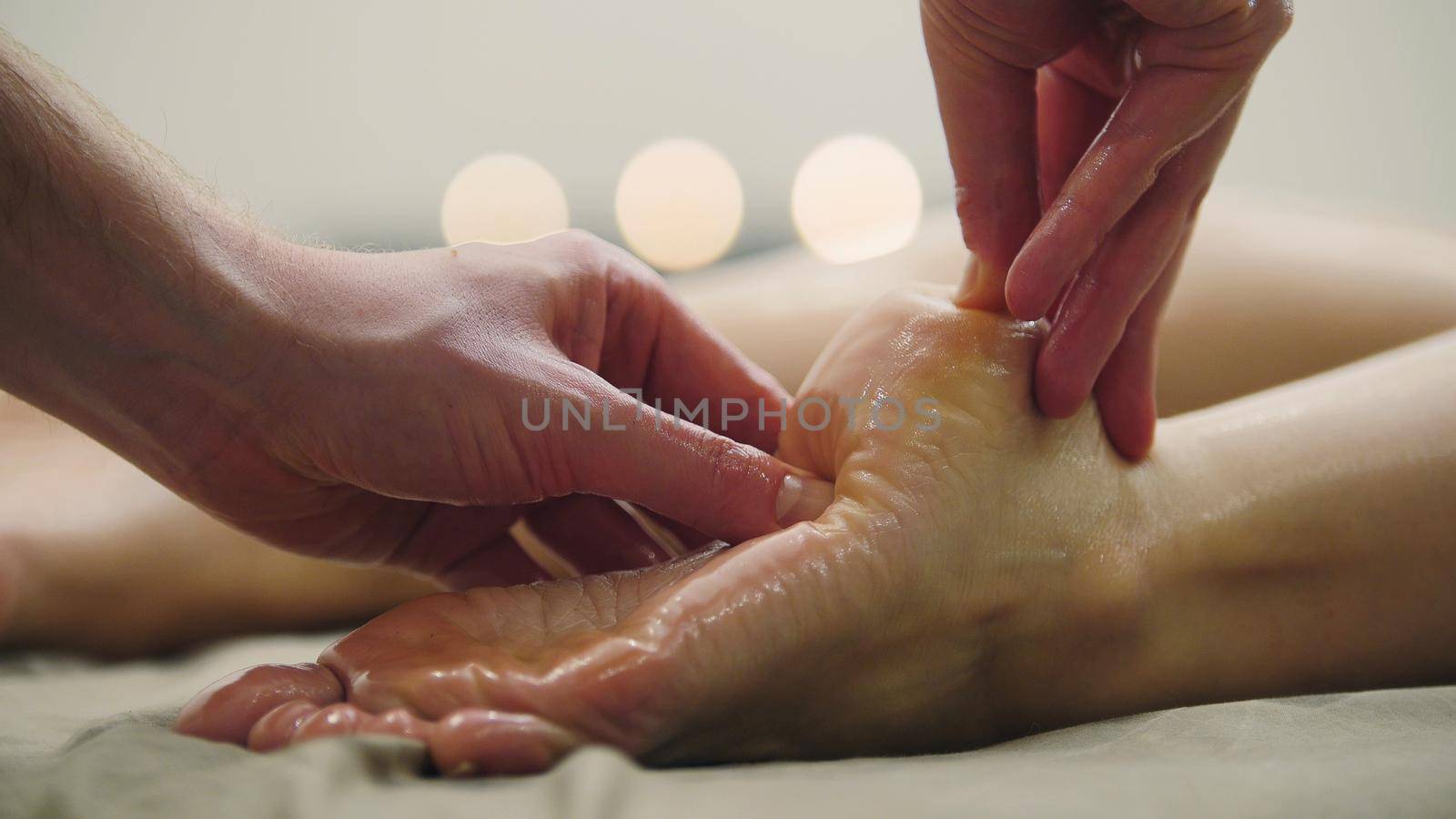 Oil massage for heel on the leg. Relaxation treatment for young female, close up, close up view