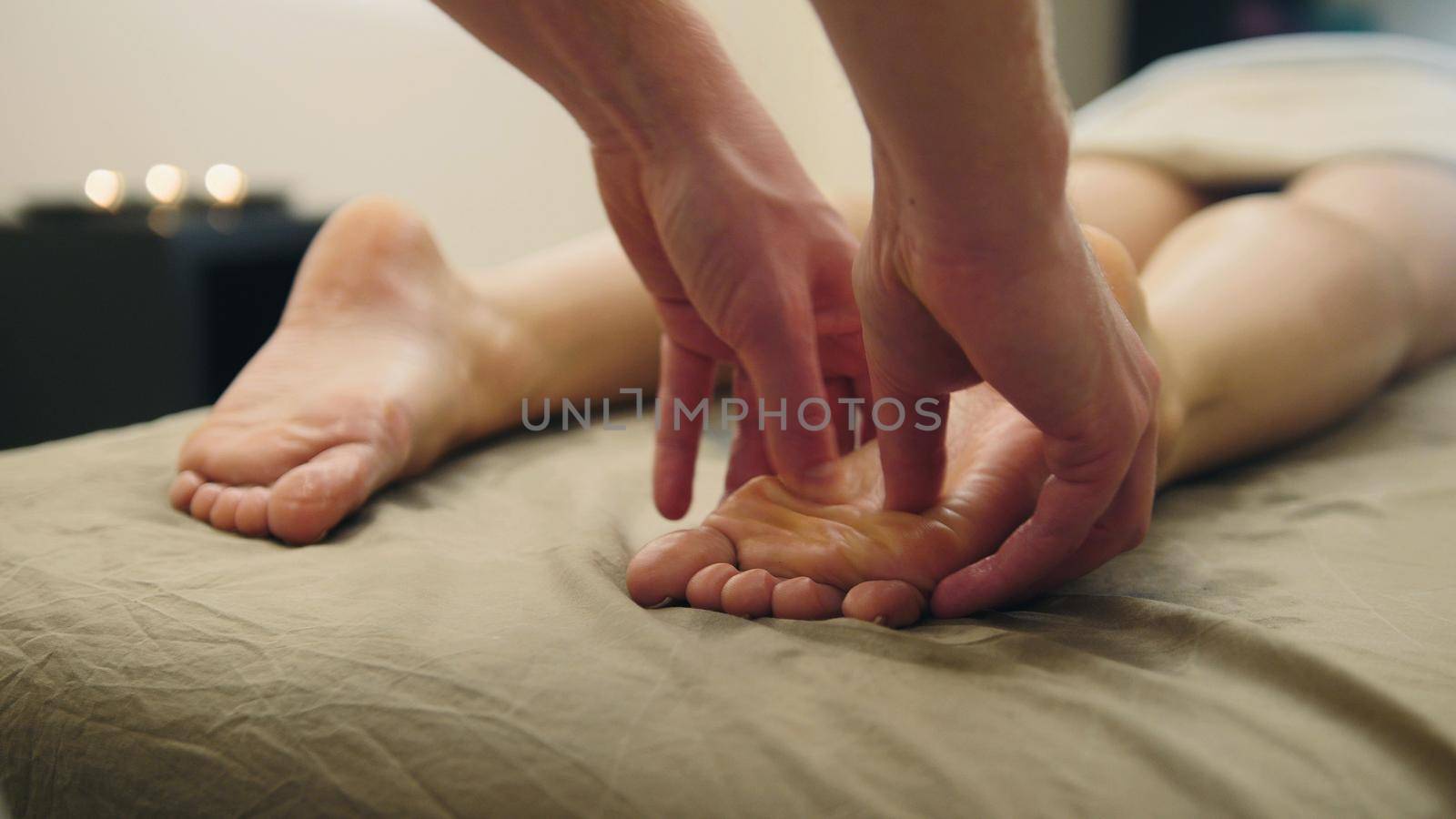 Sesame oil massage for footstep. Relaxation treatment for young female, close up by Studia72