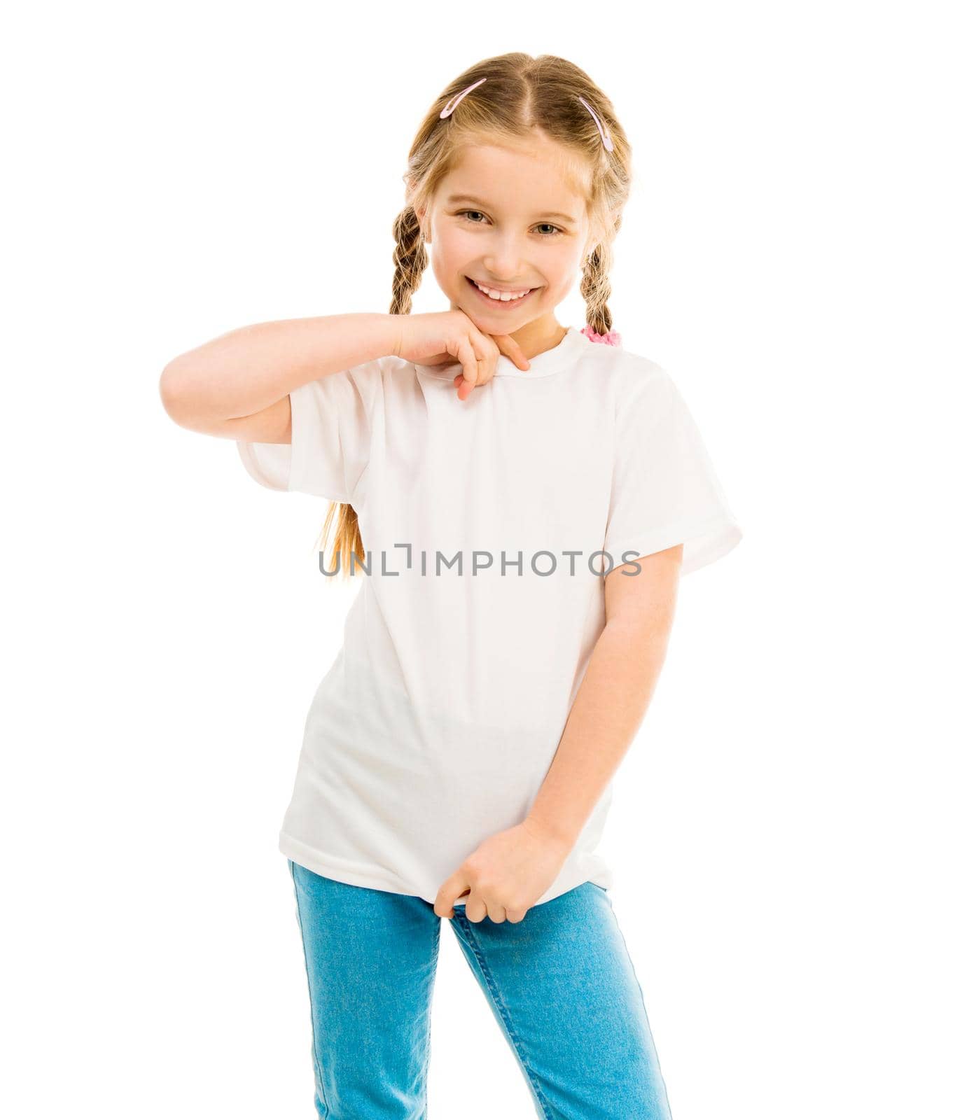 cute little girl in a white T-shirt and blue jeans on a white background shows a T-shirt on