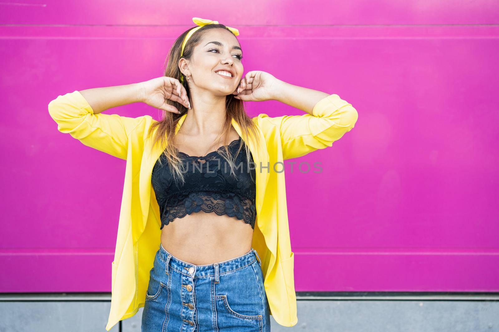 Young woman wearing a yellow jacket and headband by javiindy