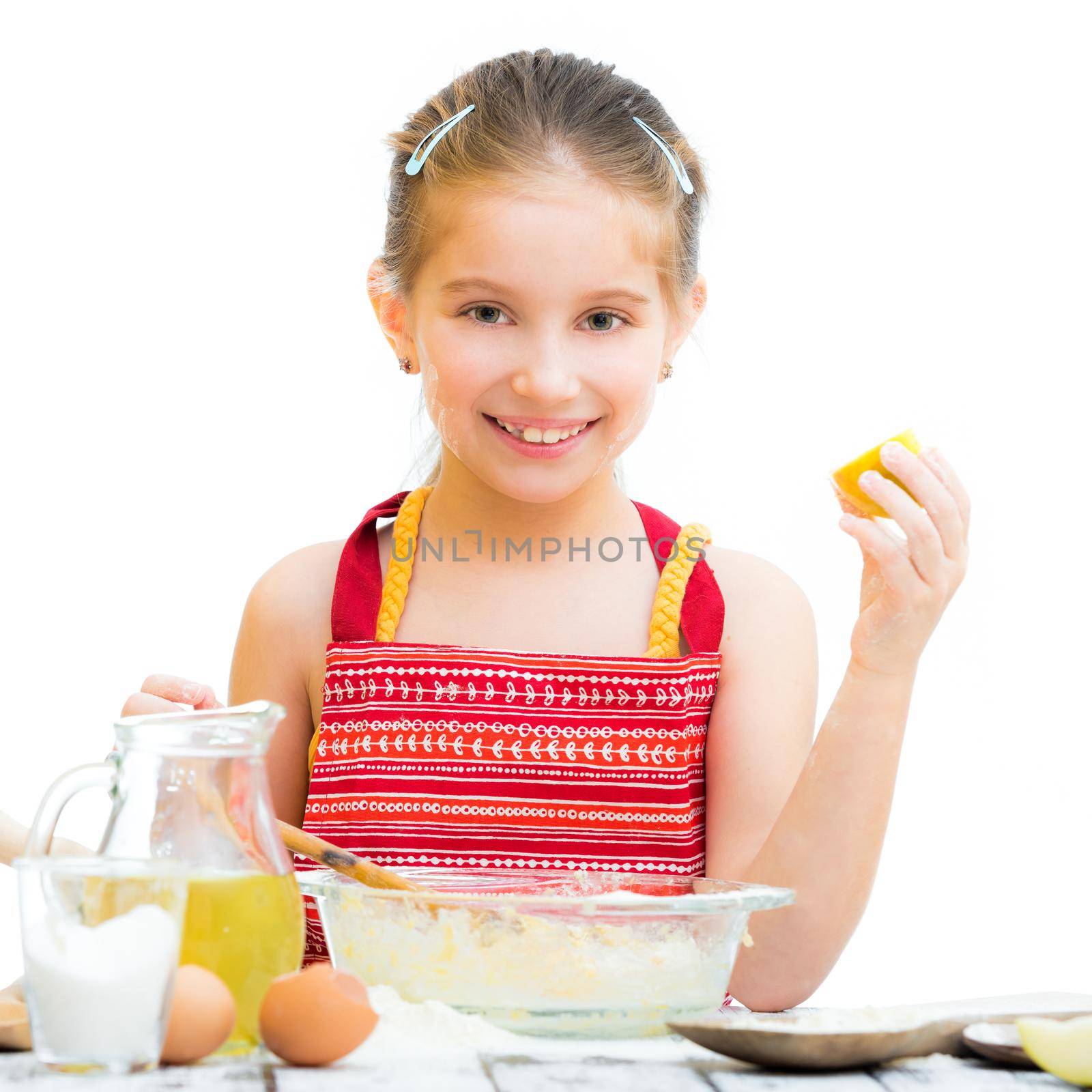 cute llittle girl cooking cakes isolated on a white background