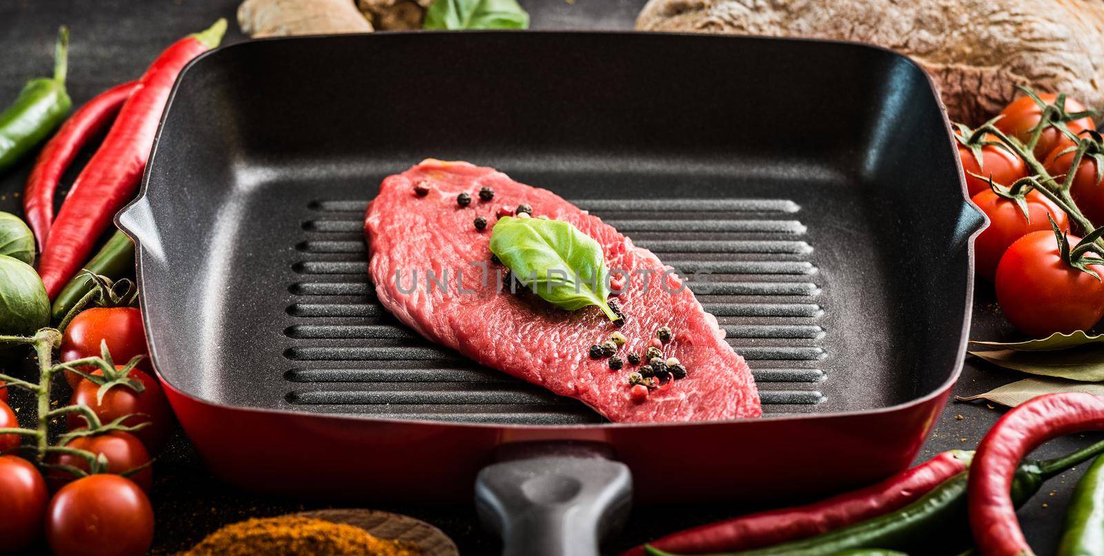 piece of raw beef in a pan