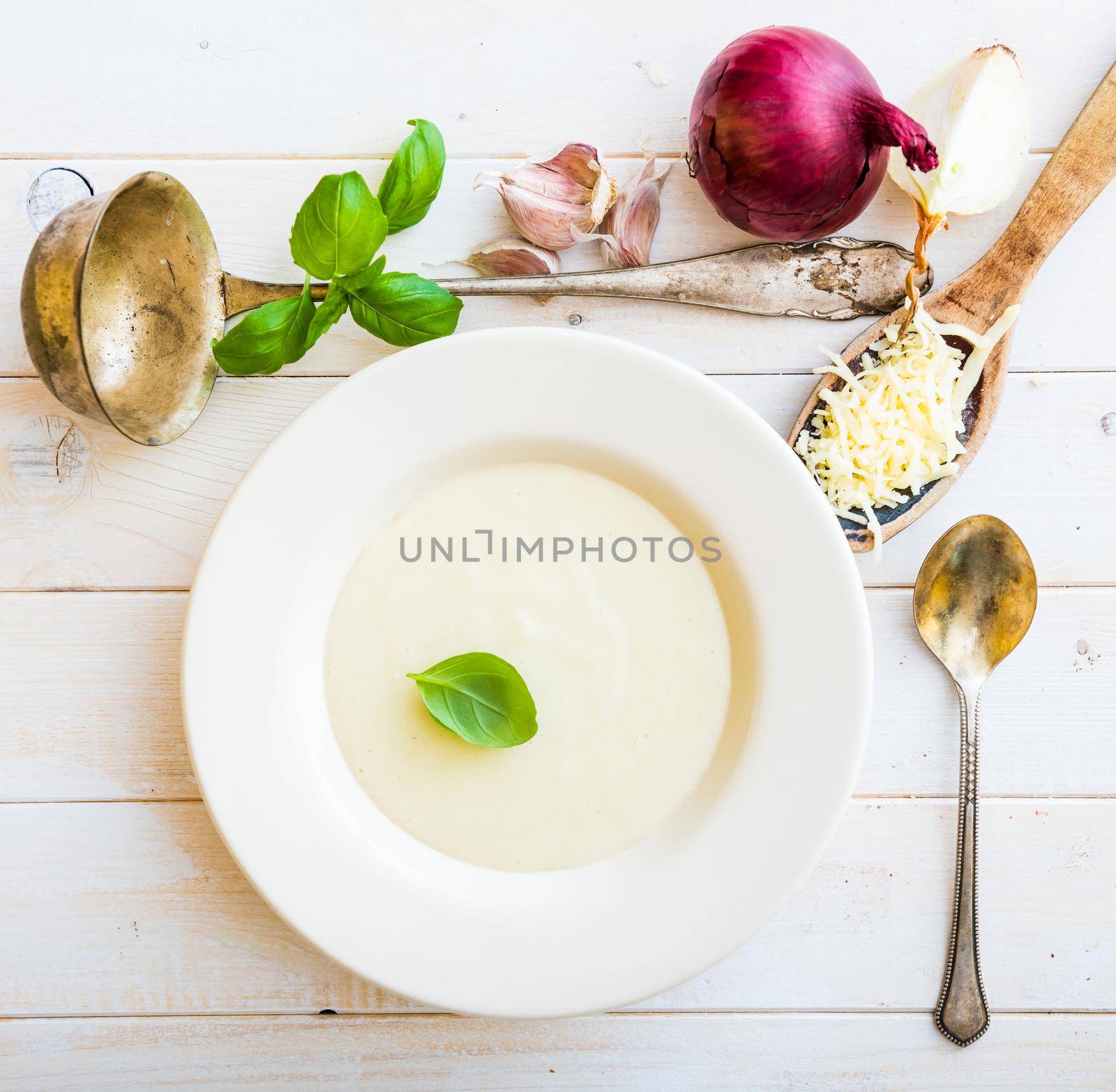 onion soup puree in a white plate cheese on the table