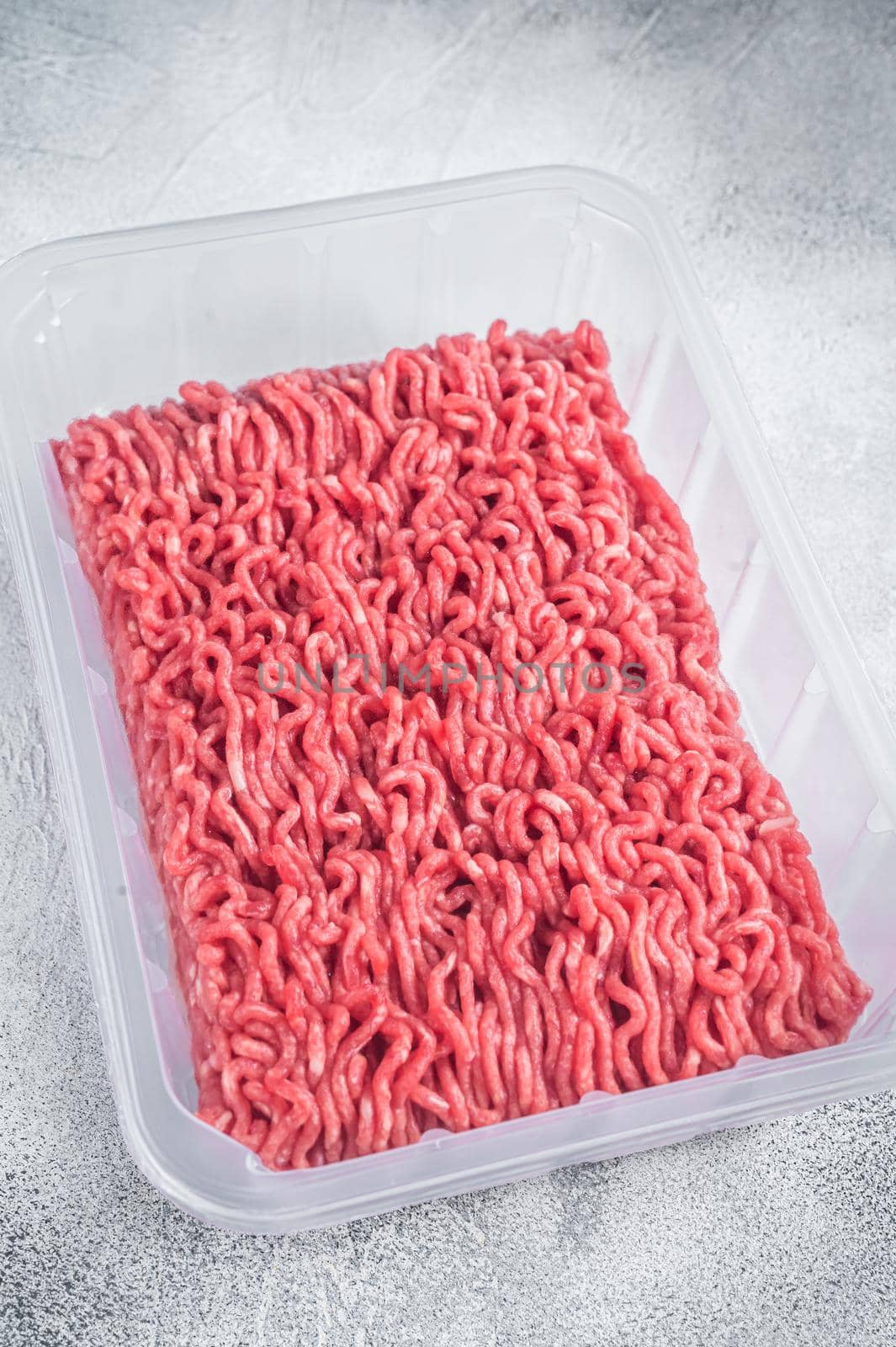Raw ground beef and pork meat in vacuum packaging from super market. White background. Top view.