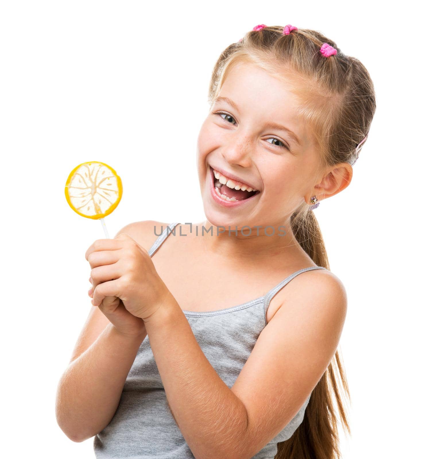 Adorable little girl with yellow lemon lollipop isolated over white background
