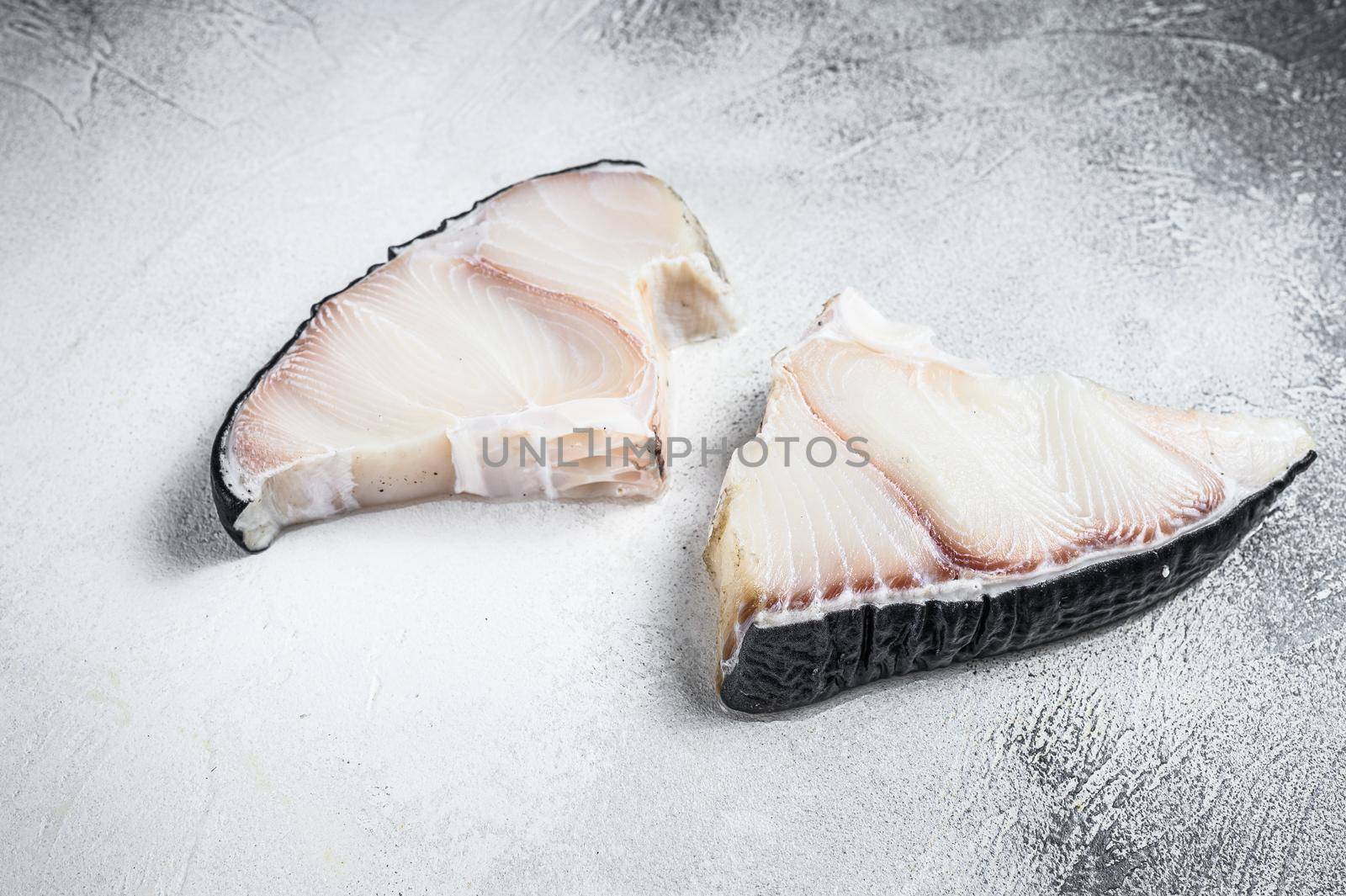 Raw Shark fish steaks on a kitchen table. White background. Top view by Composter