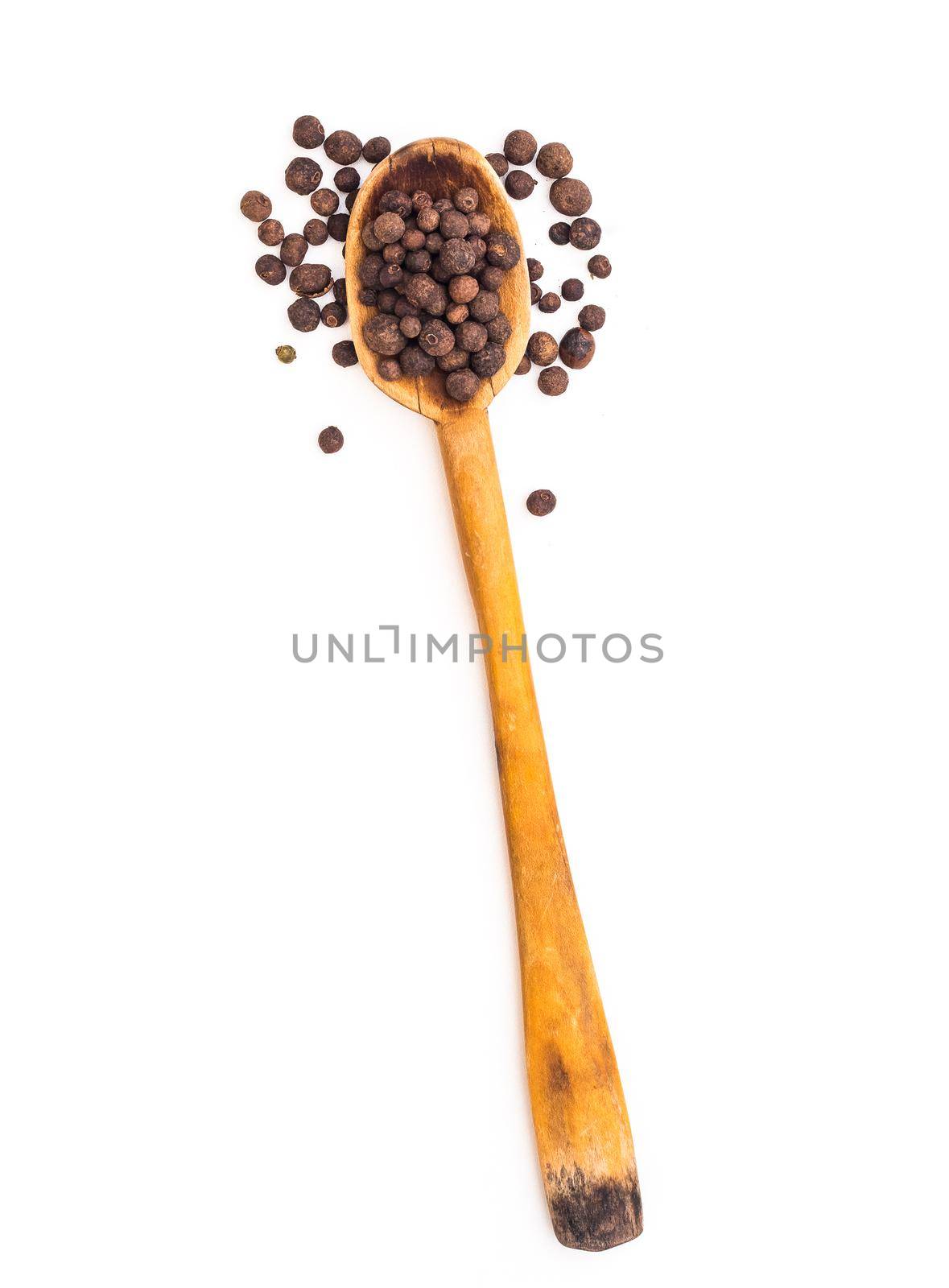 black pepper in a wooden spoon isolated on a white background