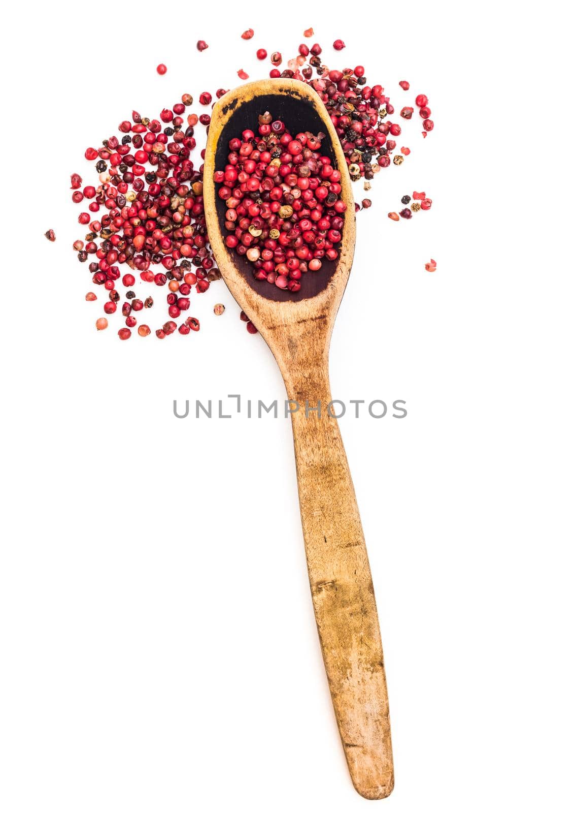 fresh pepper in wooden spoon isolated on a white background