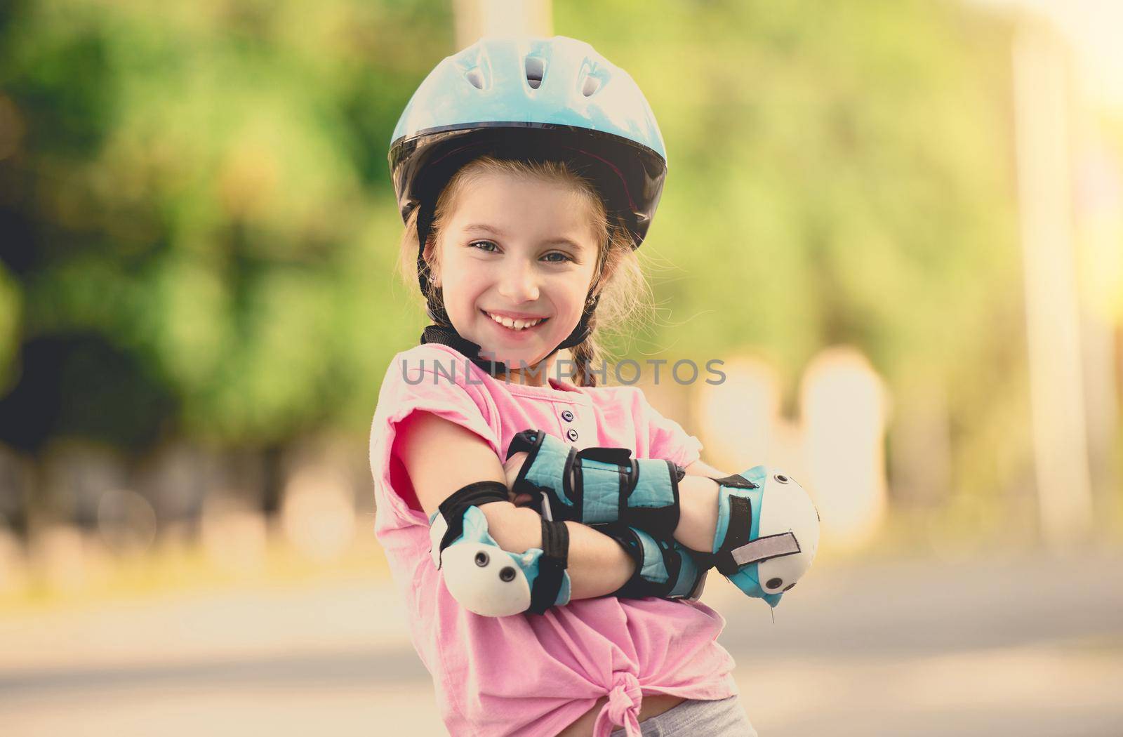 beautiful girl on the rollers in helmet and protection