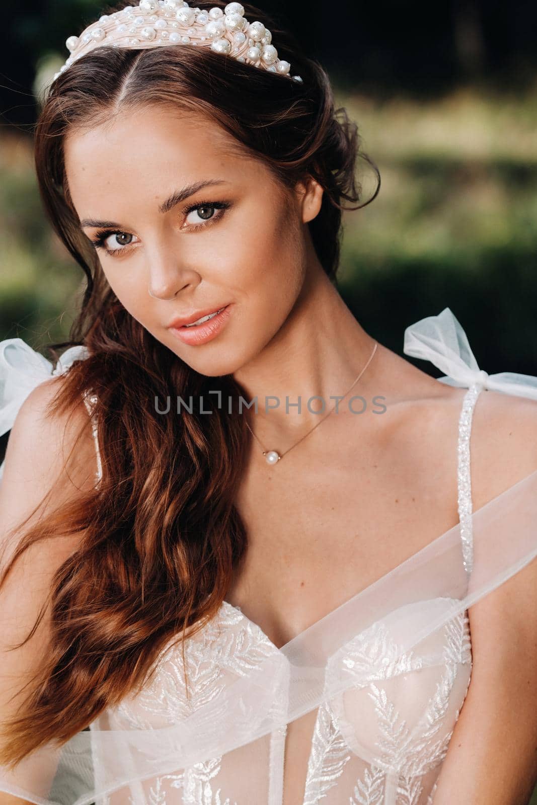 Close-up portrait of an Elegant bride in a white dress in nature in a nature Park.Model in a wedding dress and gloves .Belarus by Lobachad