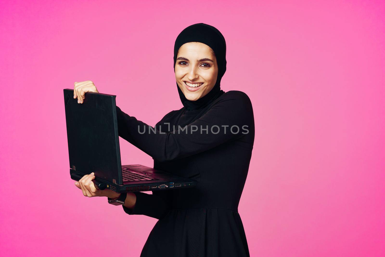 cheerful muslim woman with laptop education student internet technology by Vichizh