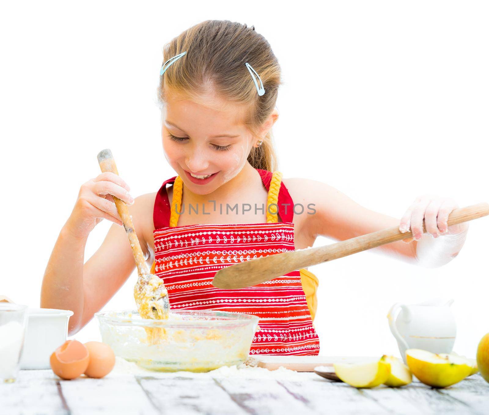 cutre little girl making dough isolated on a white background