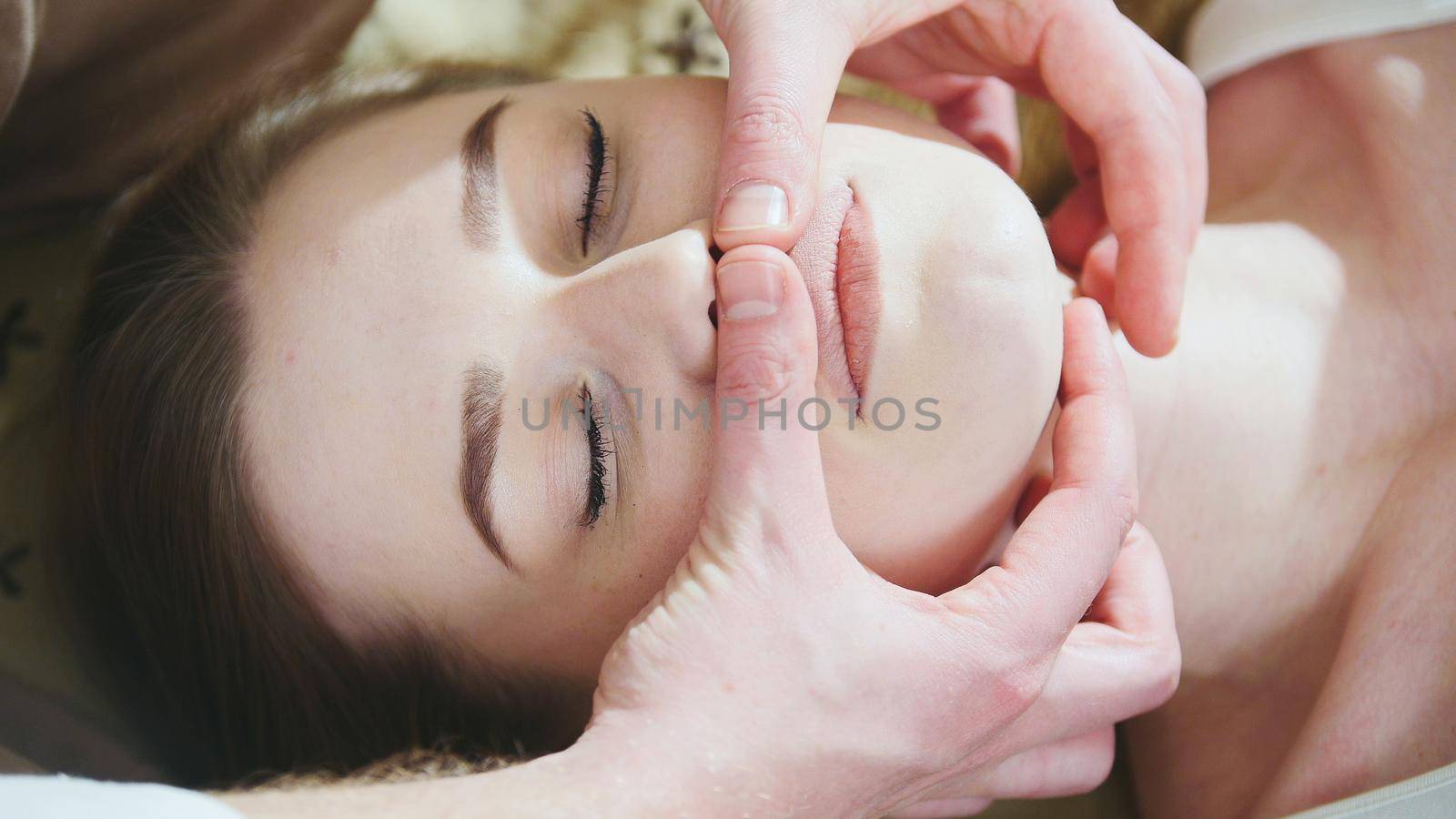 Thai massage session for head and face of attractive female, close up