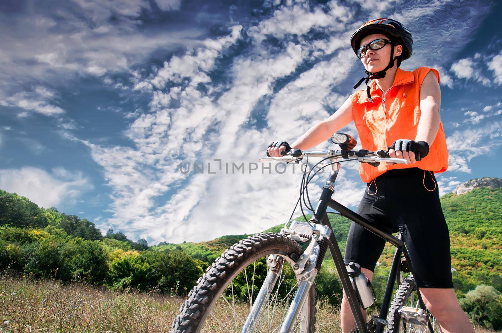 Mountain female Biker and blue sky background
