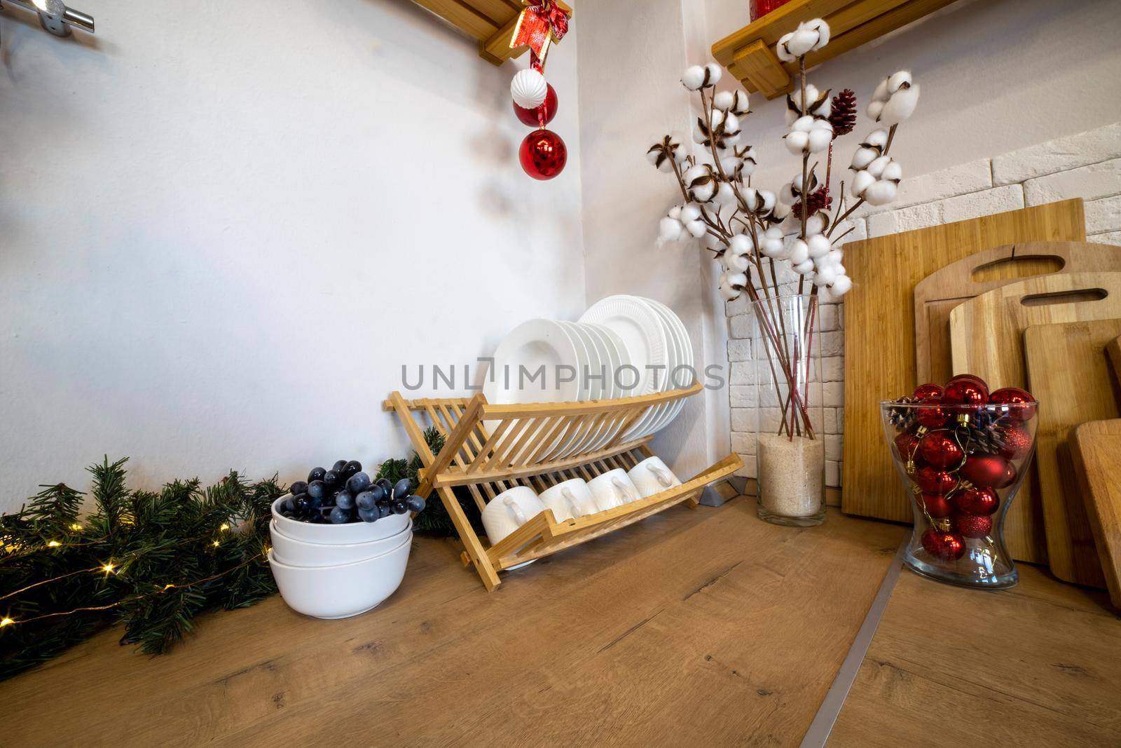 cozy kitchen decorated for Christmas. plate dryer on a wooden work surface