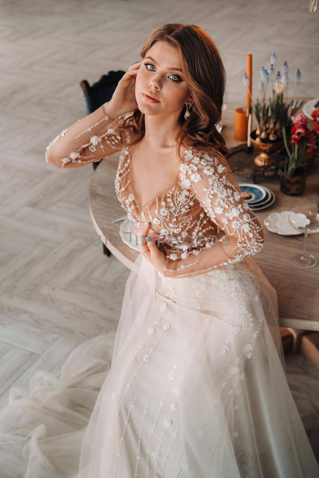 A luxurious bride in a wedding dress in the morning in her interior by Lobachad