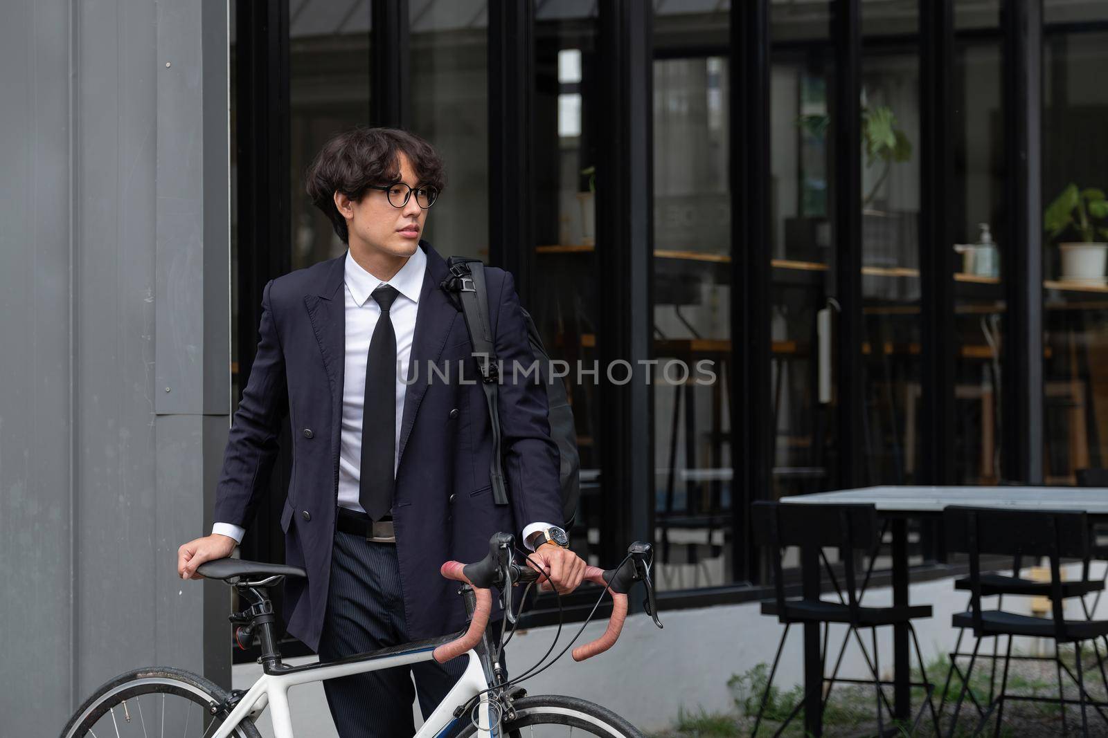 Asian businessman pushing his bicycle in the morning preparing to ride his bicycle to work. Eco tranportation by nateemee