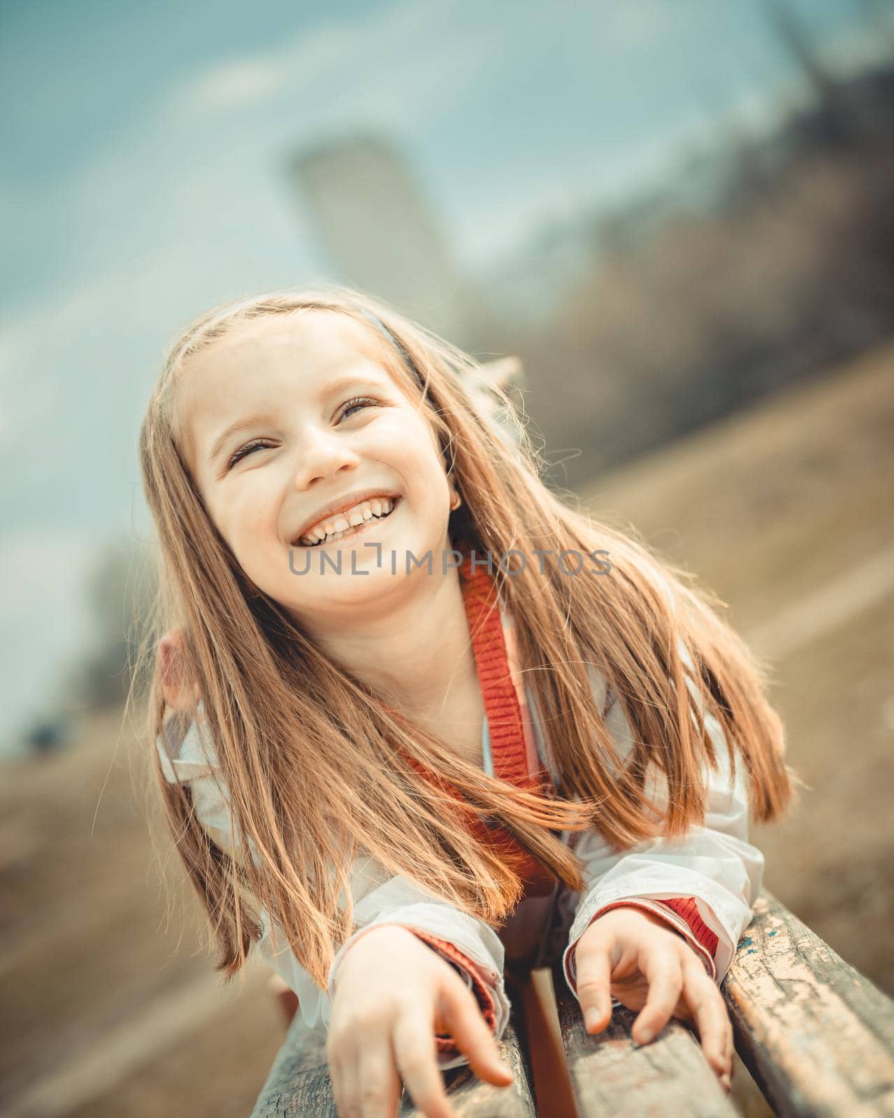 Close-up portrait of a pretty smiling liitle girl