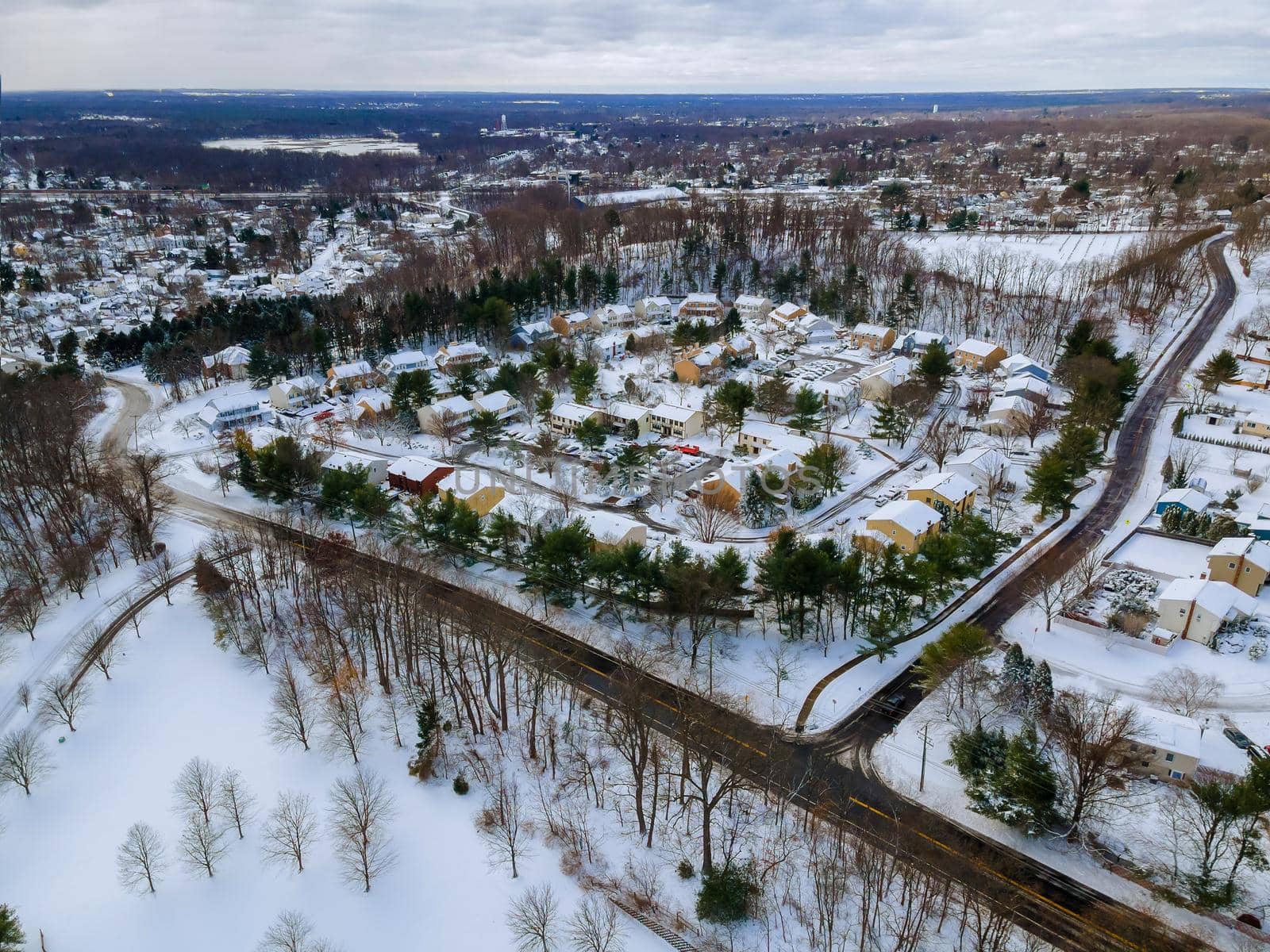 Aerial top view of landscape small town with home complex covered in the wonderful winter scenery white snow