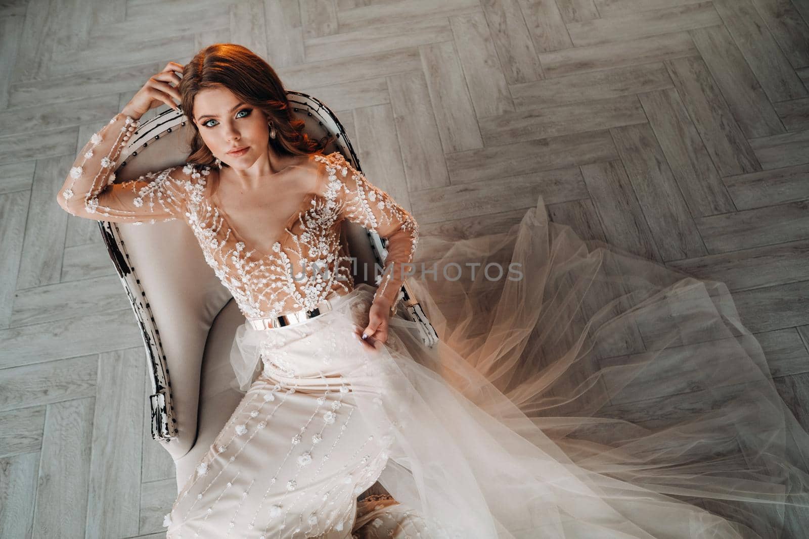 A luxurious bride in a wedding dress in the morning in her interior by Lobachad