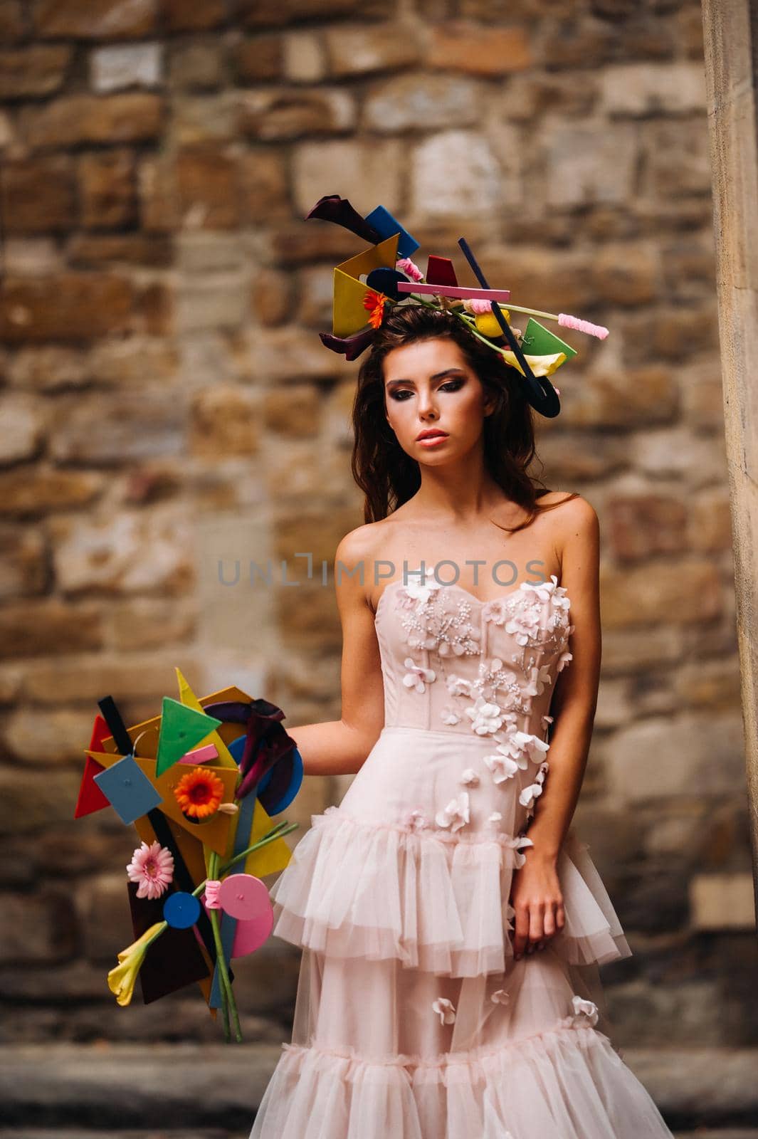beautiful stylish girl model in a pink wedding dress photographed in Florence, holding an unusual bouquet, bride model with a bouquet in her hands, photo session of the bride in Florence