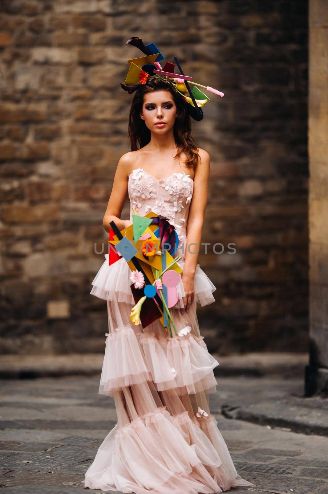 beautiful stylish girl model in a pink wedding dress photographed in Florence, holding an unusual bouquet, bride model with a bouquet in her hands, photo session of the bride in Florence