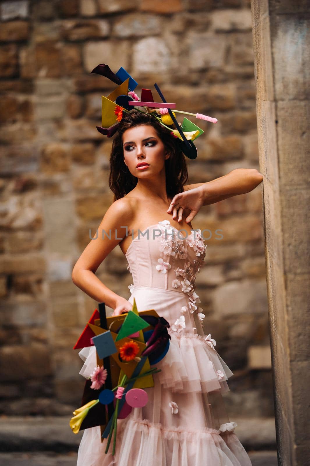 beautiful stylish girl model in a pink wedding dress photographed in Florence, holding an unusual bouquet, bride model with a bouquet in her hands, photo session of the bride in Florence