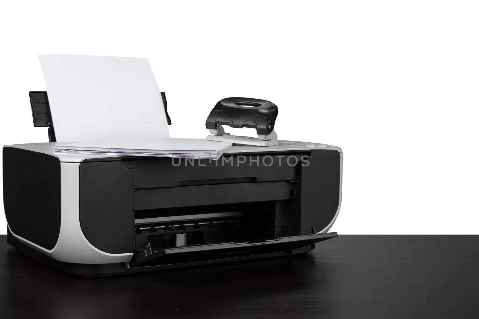 Laser home printer on table against white background, close up