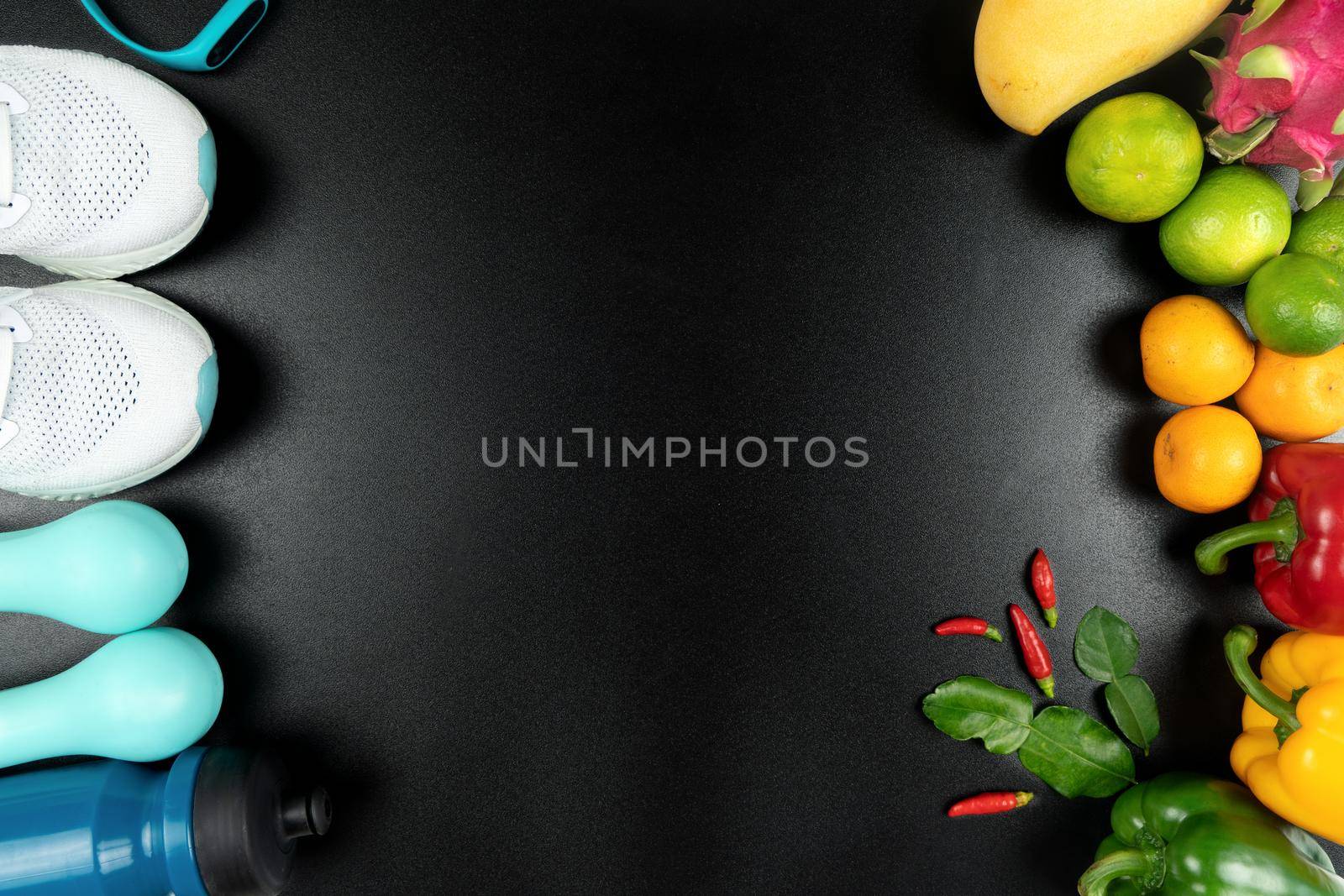 Healthy lifestyle, food and sport concept. athlete's equipment and fresh fruit on black background.