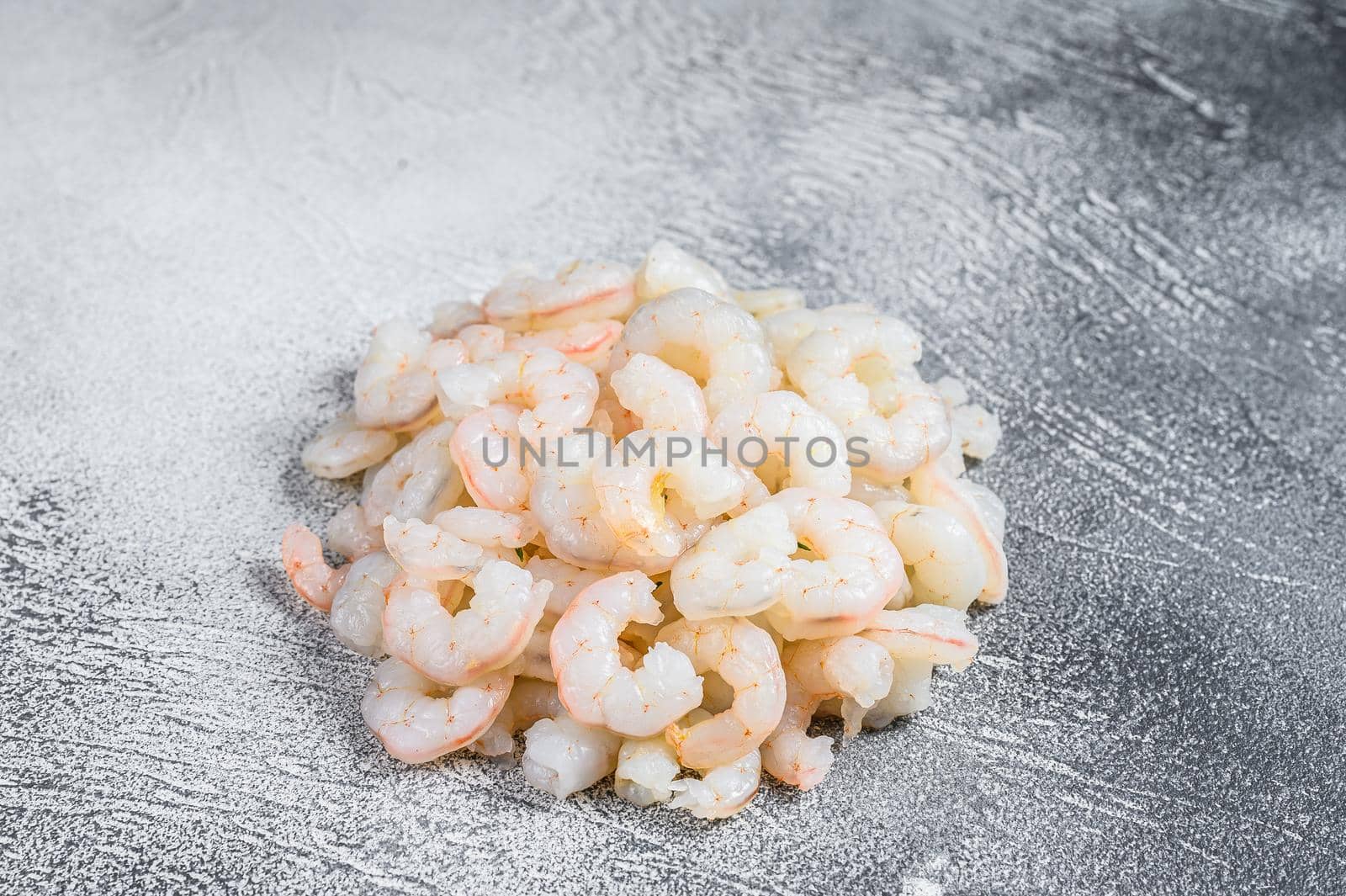 Peeled raw Shrimps, Prawns on a table. White background. top view by Composter