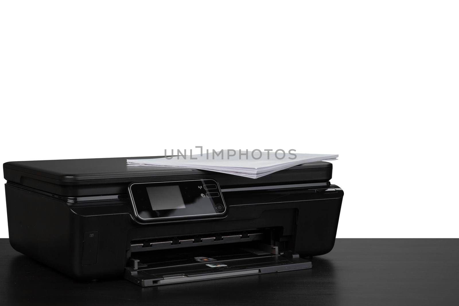 Laser home printer on table against white background, close up