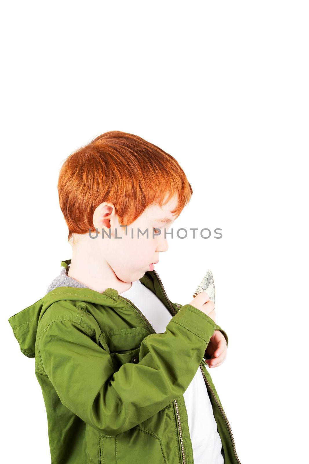 red-haired boy in a green jacket with dollars that he puts in his jacket pocket